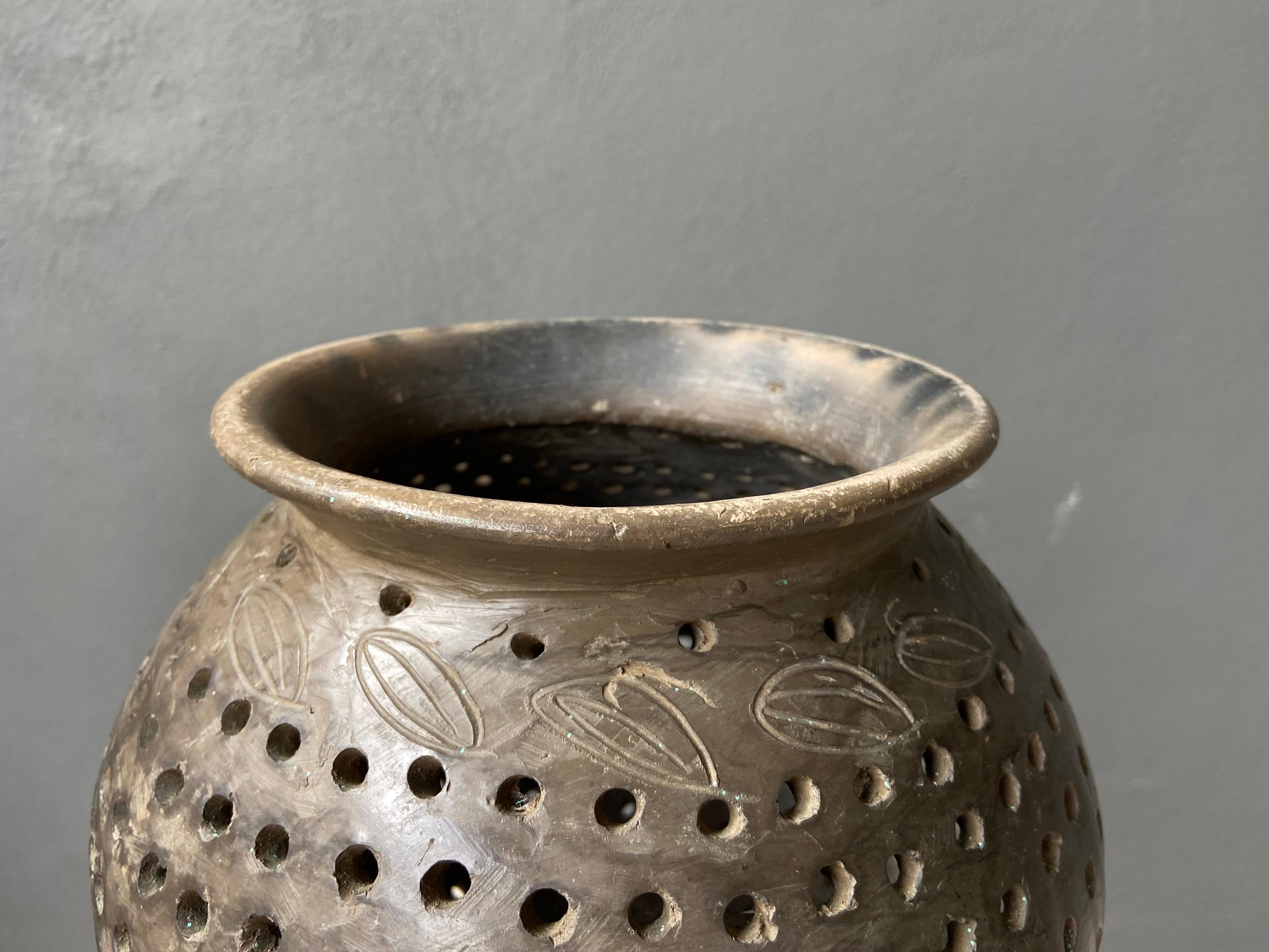 Ceramic maize strainer from Southern Oaxaca, Mexico, circa 1960's. Often referred to as Olla de Nixtamal, the vessel is used to clean out the maize before the soaking process which is typically done with limewater. This is the ancient way of