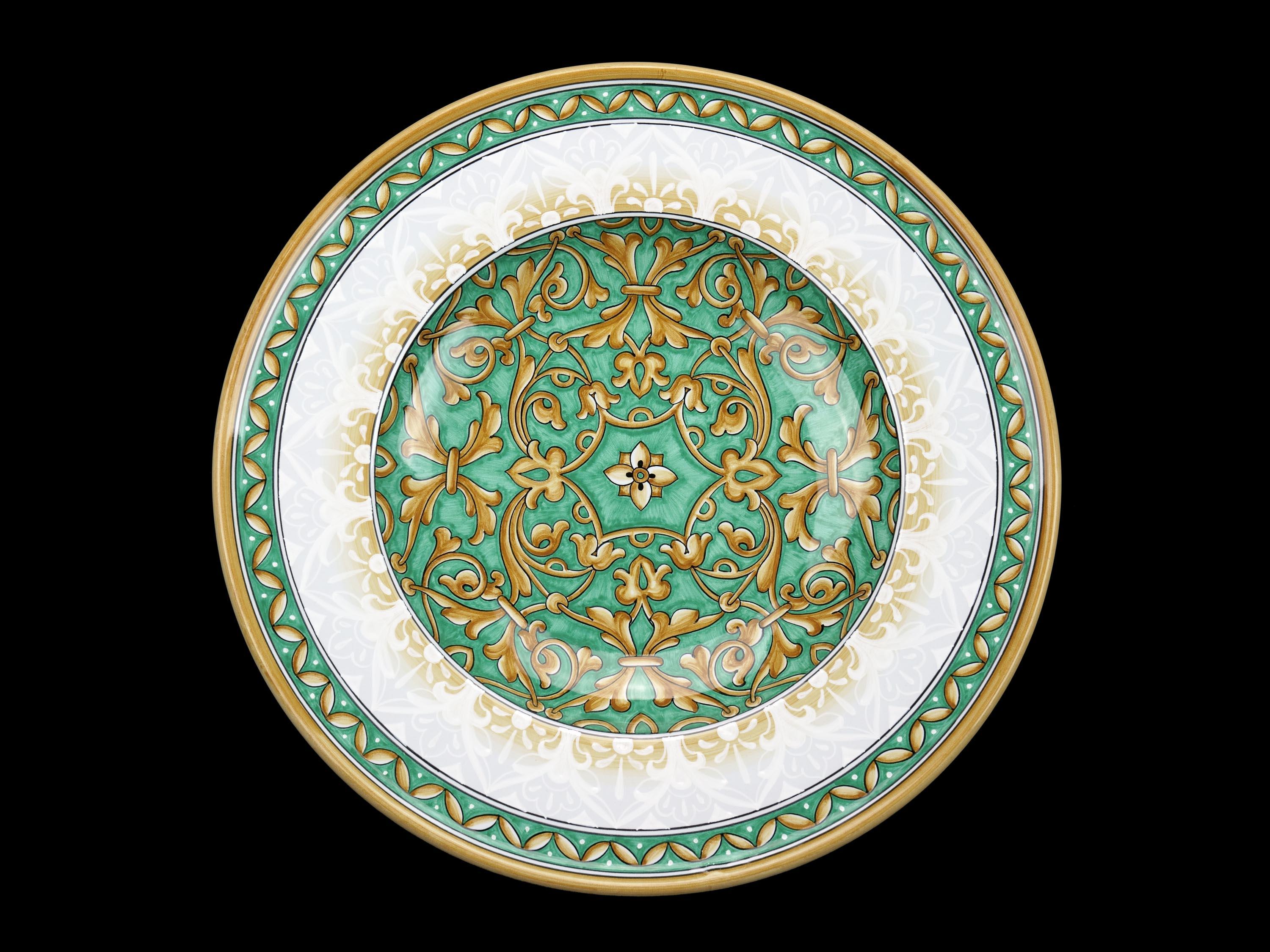 This exclusive ceramic plate is handmade and hand-painted in Italy following the original Renaissance painting technique, unchanged over time, which we observe to the letter: it is decorated in majolica painted in duotone of aquamarine and golden