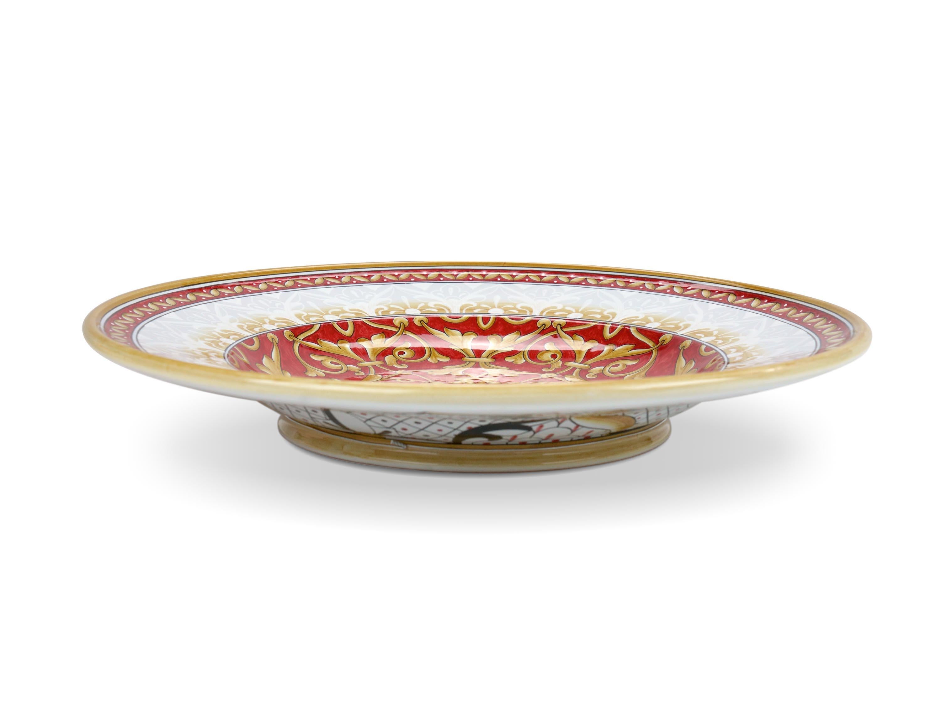This exclusive ceramic plate is handmade and hand-painted in Italy following the original Renaissance painting technique, unchanged over time, which we observe to the letter: it is decorated in majolica painted in duotone of red and golden yellow