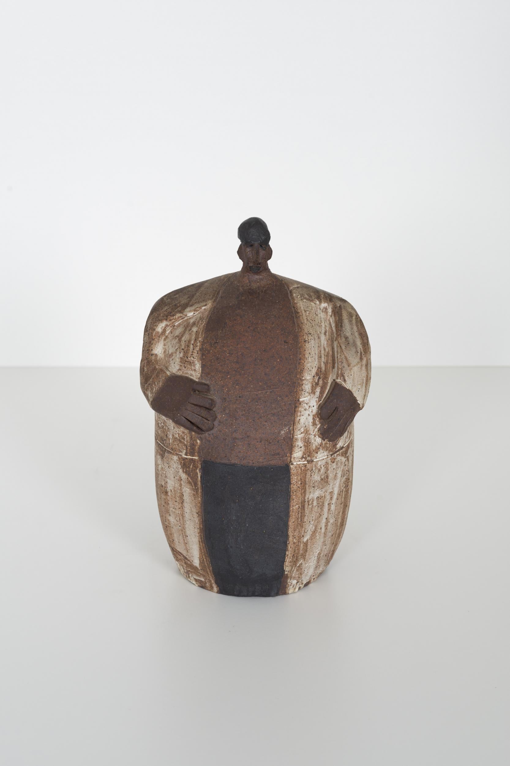 Ceramic male figure, fired stoneware with monochromatic pattern.
Incised signature underside.