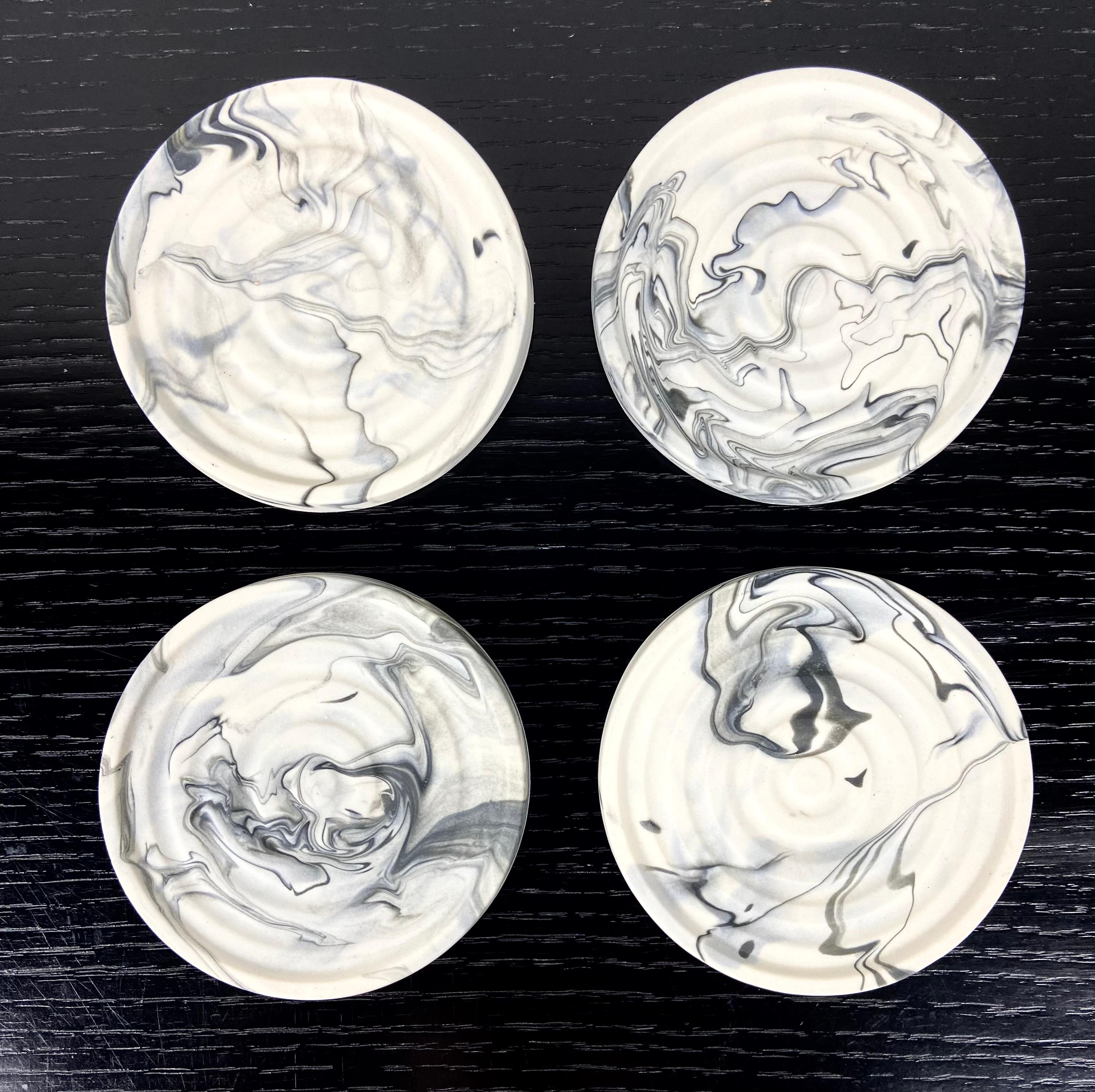 A set of 4 marbleized porcelain coasters by Upstate NY ceramist Andrew Molleur. Each coaster has a different pattern. Please note that your set will have variations and may not be exactly as pictured in terms of the patterns.  Each coaster is hand