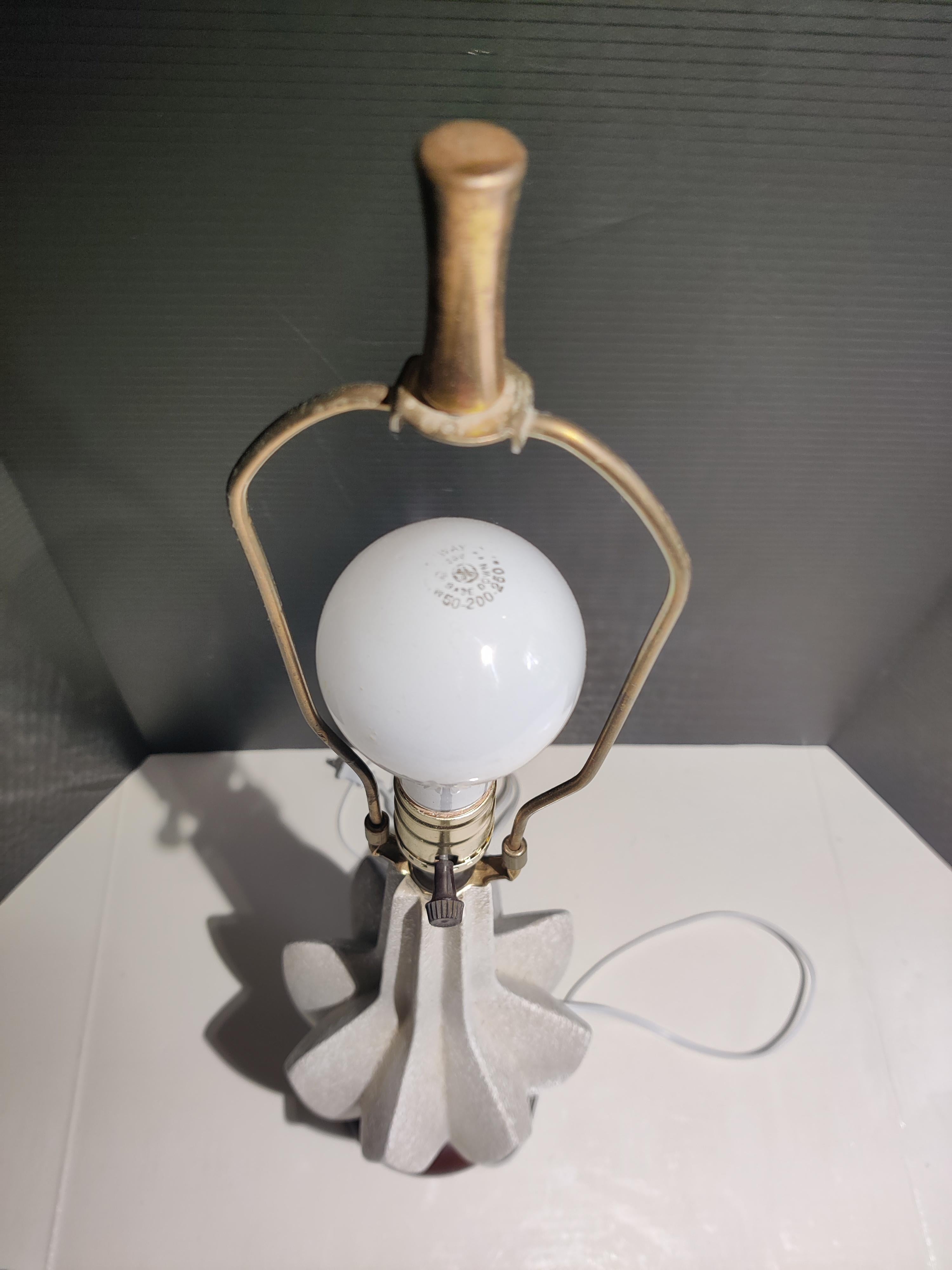 Ceramic mid-century table lamp with multi-color accents.
Ceramic lamp is in good condition.
Some wear on wood base.   See pic.   Wood base 5.5,
Re-wired.  In working condition.   
Tarnished brass finial.    1.75 tall. 