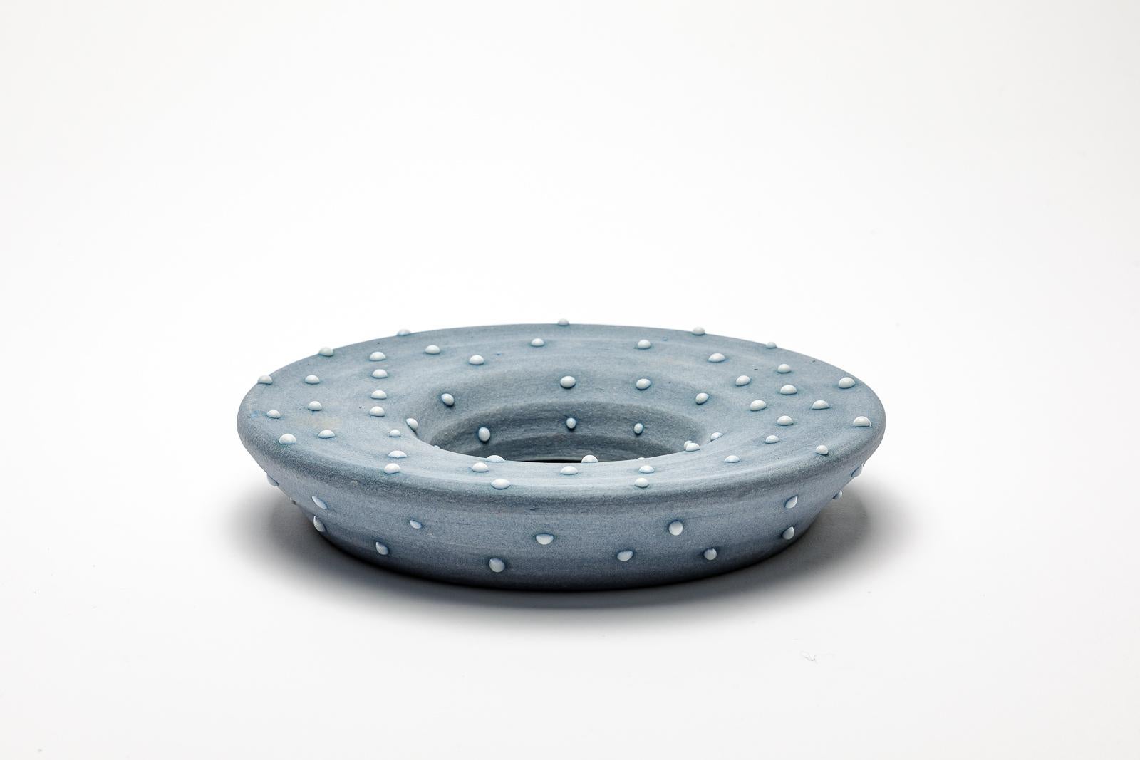 Blue glazed ceramic mirror with white dots by Mia Jensen.
Artist signature under the base. Circa 2023-2024.
H : 1.6’ x 8.1’ inches.
