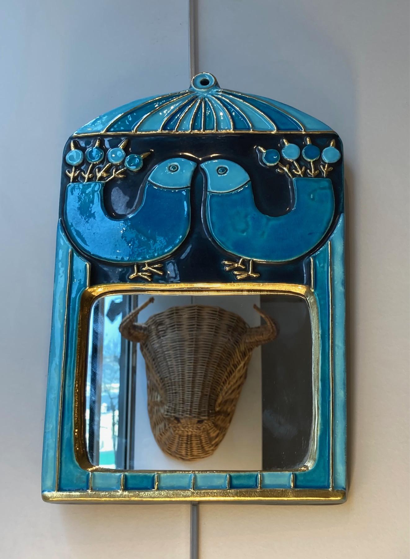 A ceramic wall mirror, with 2 birds facing each other, enameled in 2 shades of blue, black and gold.
Mithé Espelt (born 1923)
Lunel, south of France,
circa 1970
This poetic work of art demonstrates Mithé Espelt's talent for design and her