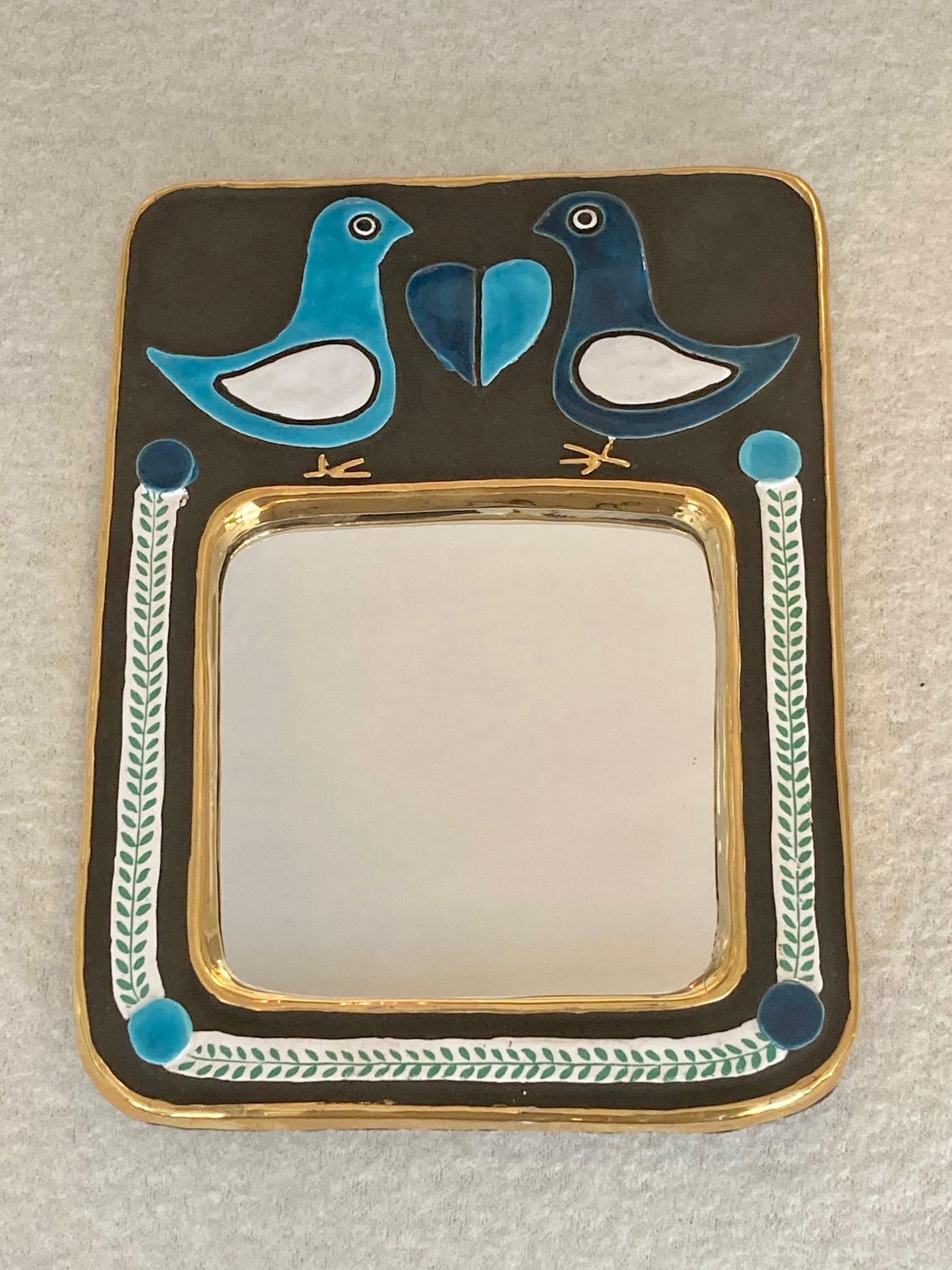 A ceramic wall mirror, 2 doves facing each other with a heart in the middle.
 Enameled in 2 shades of blue, white, black and gold.
Original green felt at the back, in very good condition.
Mithé Espelt (born 1923)
Lunel, south of France,
circa