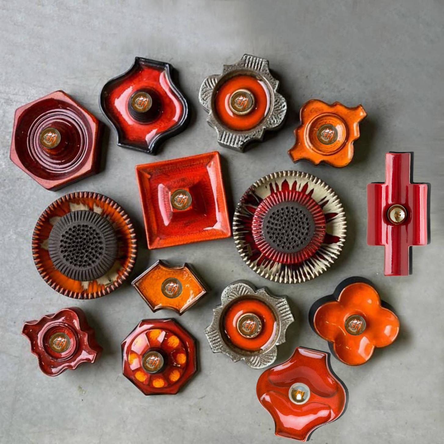 Stunning mix of round wall lights/flush mounts with an unusual shape, made with rich brown, green, red, and orange colored ceramics, manufactured in the 1970s in Germany. We also have a multitude of unique colored ceramic light sets and