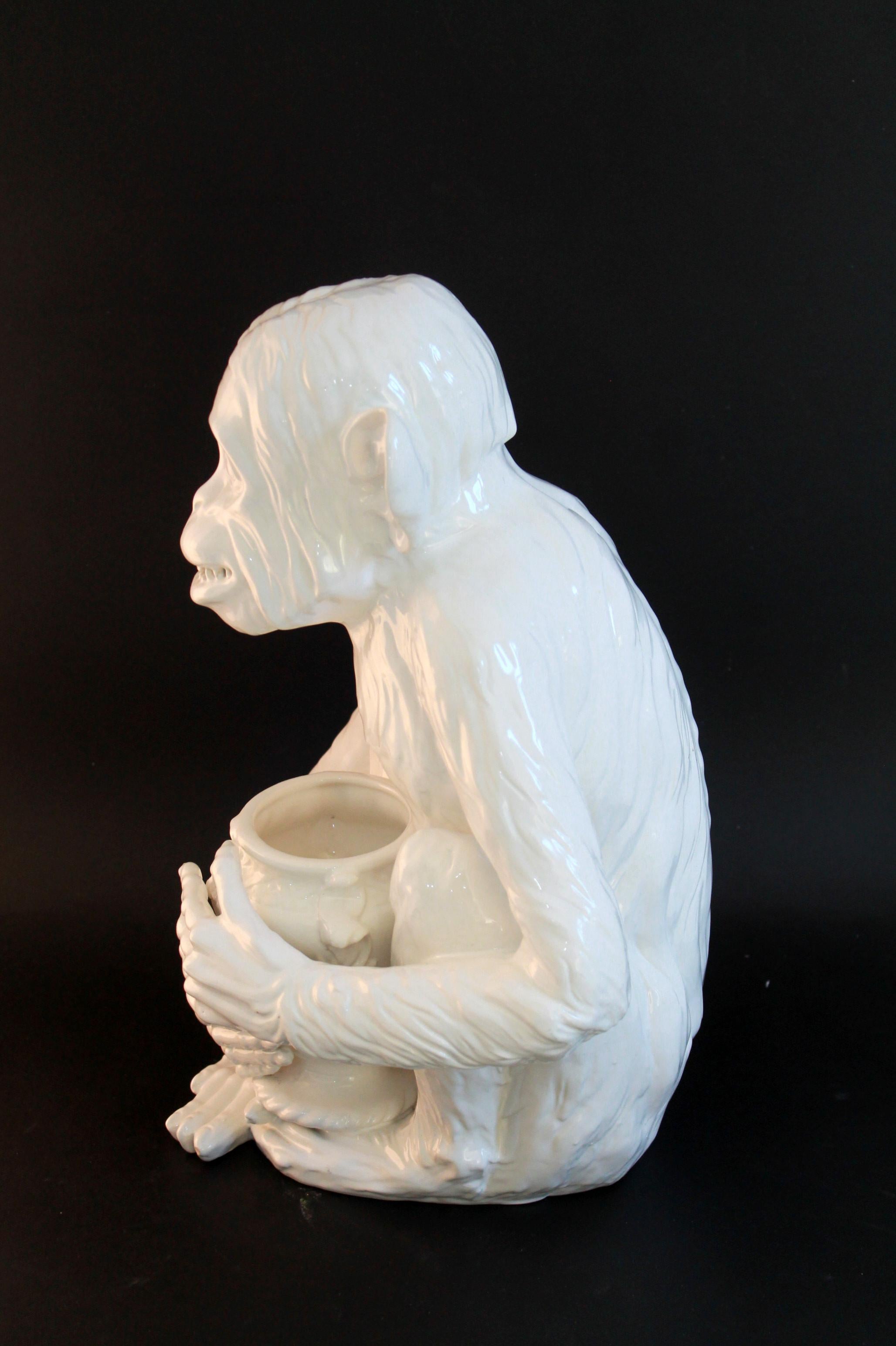 Rare 1950s Italian-made Hollywood regency ceramic jardiniere monkey seated holding a vase/urn.

Measurements: 
Jardiniere - 41h x 24d x 32w cm

Condition: 
Overall excellent condition and presented unrestored with no visible signs of losses, chips,