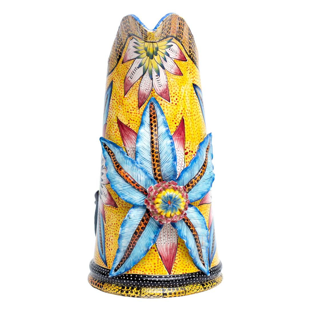 Wiseman Ceramics presents a charming ceramic Monkey jug, handcrafted by artisans Riya, George, and Thabo in South Africa. Standing 12 inches tall with dimensions of 10 inches in length and 6 inches in width, this jug features a handle shaped like a
