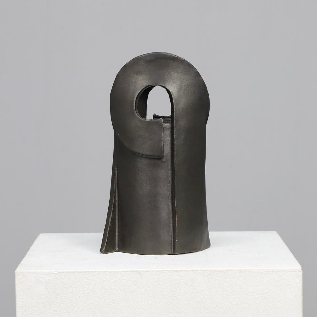 This striking ceramic piece exemplifies the sculptural approach of Gisbert and Barbara Haberland, whose works from the 1970s explored the boundary between functional form and pure abstraction. The dark-toned glaze, smooth yet architectural lines,