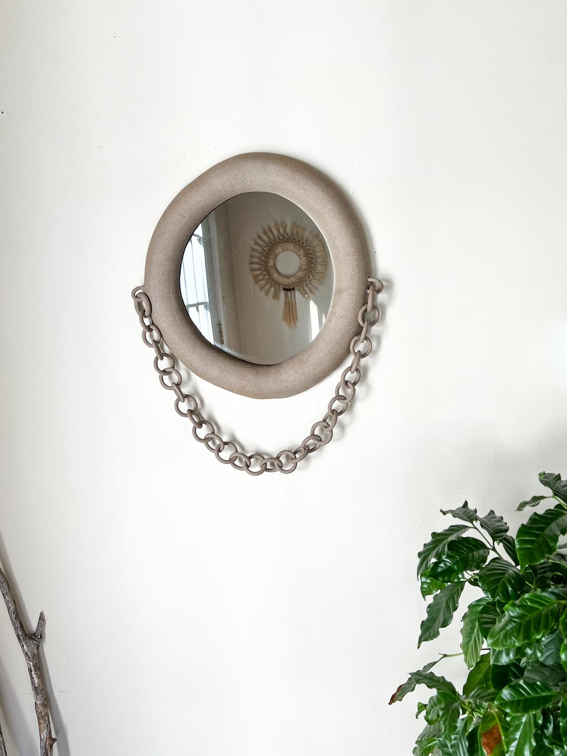 Introducing our exquisite handmade ceramic mirror, crafted with a rustic charm that adds a touch of warmth and character to any space. This one-of-a-kind piece showcases a beautifully textured ceramic frame, meticulously handcrafted to create a