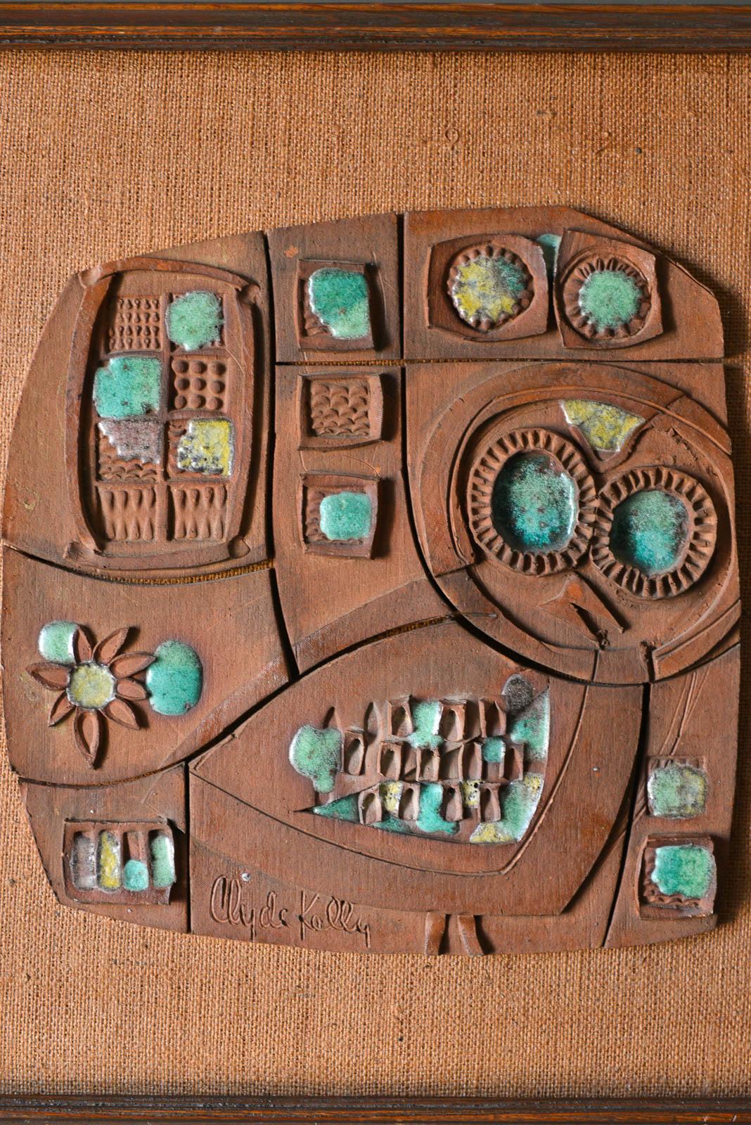 Ceramic panel by California Artist/Craftsman Clyde Kelly, circa 1968. Beautiful ceramic stoneware with bits of glaze in this abstract form. Original framing with burlap backing. Signed by the artist.

Measures: 26