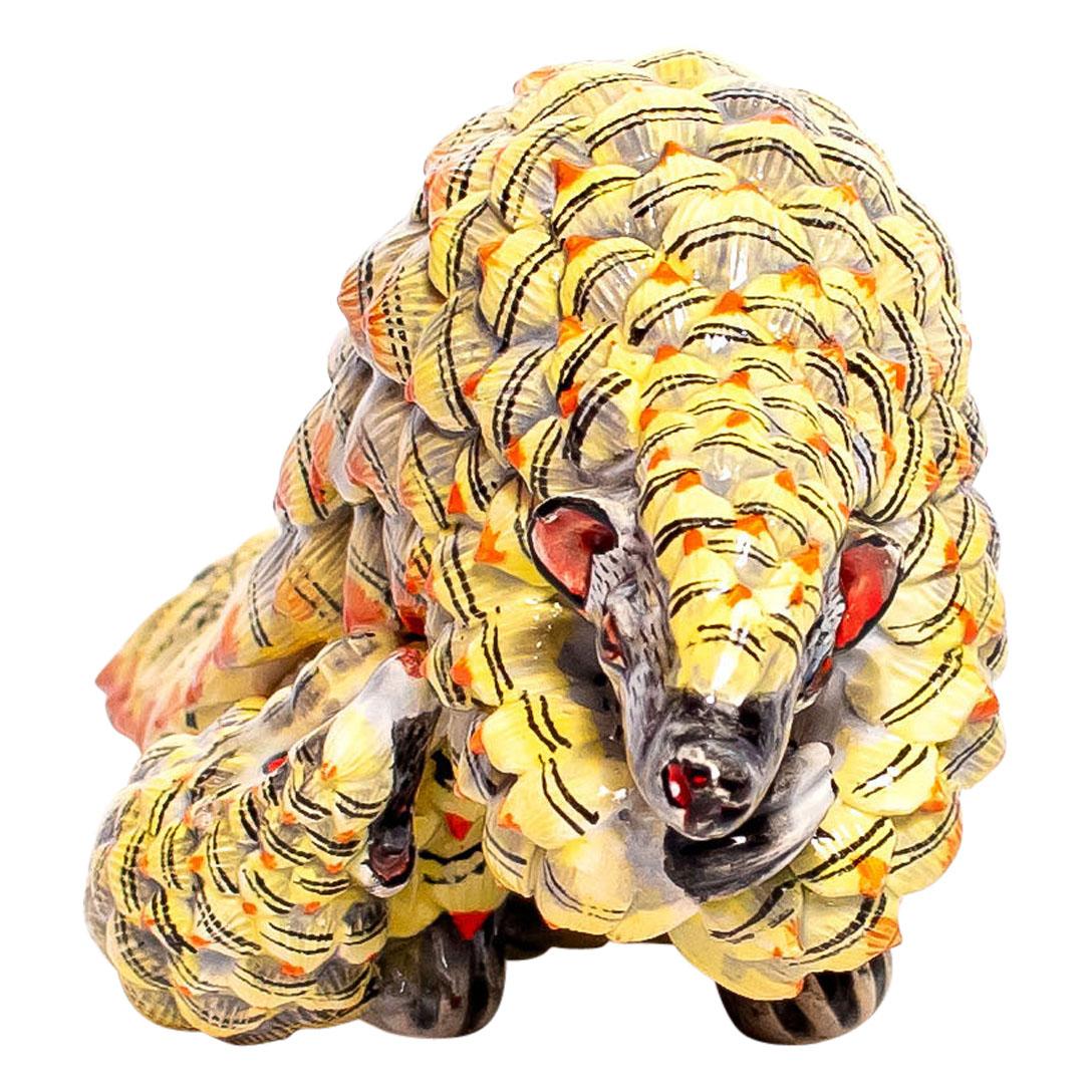 Wiseman Ceramics proudly presents a ceramic Pangolins sculpture, meticulously crafted by artisans Nqobile and Thabo under the design of Wiseman Ndlovu in South Africa. This sculpture measures 3 inches high with dimensions of 7 inches in length and 3