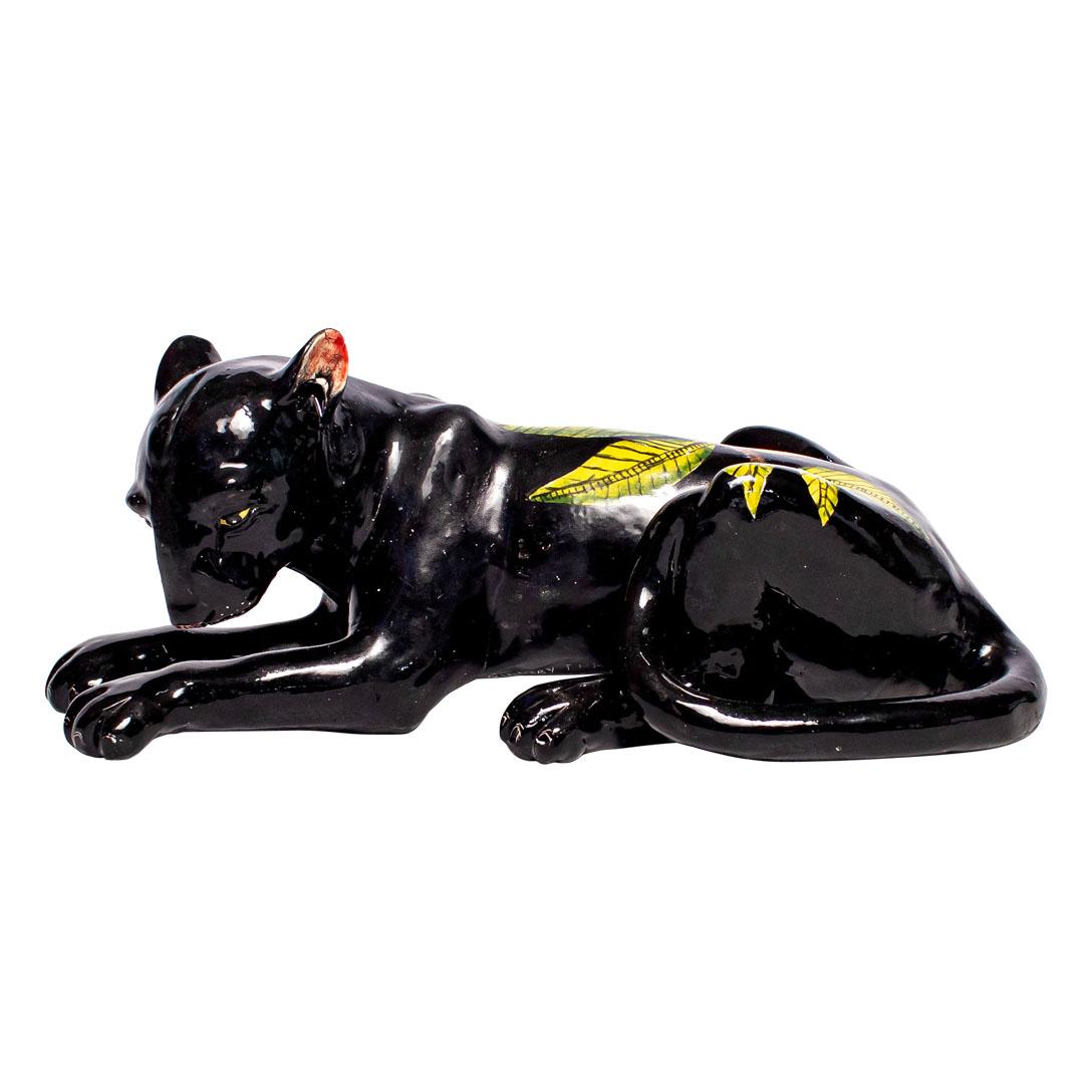Wiseman Ceramics, a renowned pottery studio in South Africa, presents a striking ceramic Black Panther sculpture, meticulously hand-sculpted by Thabo and intricately hand-painted by Lindo. This masterpiece measures 4 inches high, 10 inches long, and