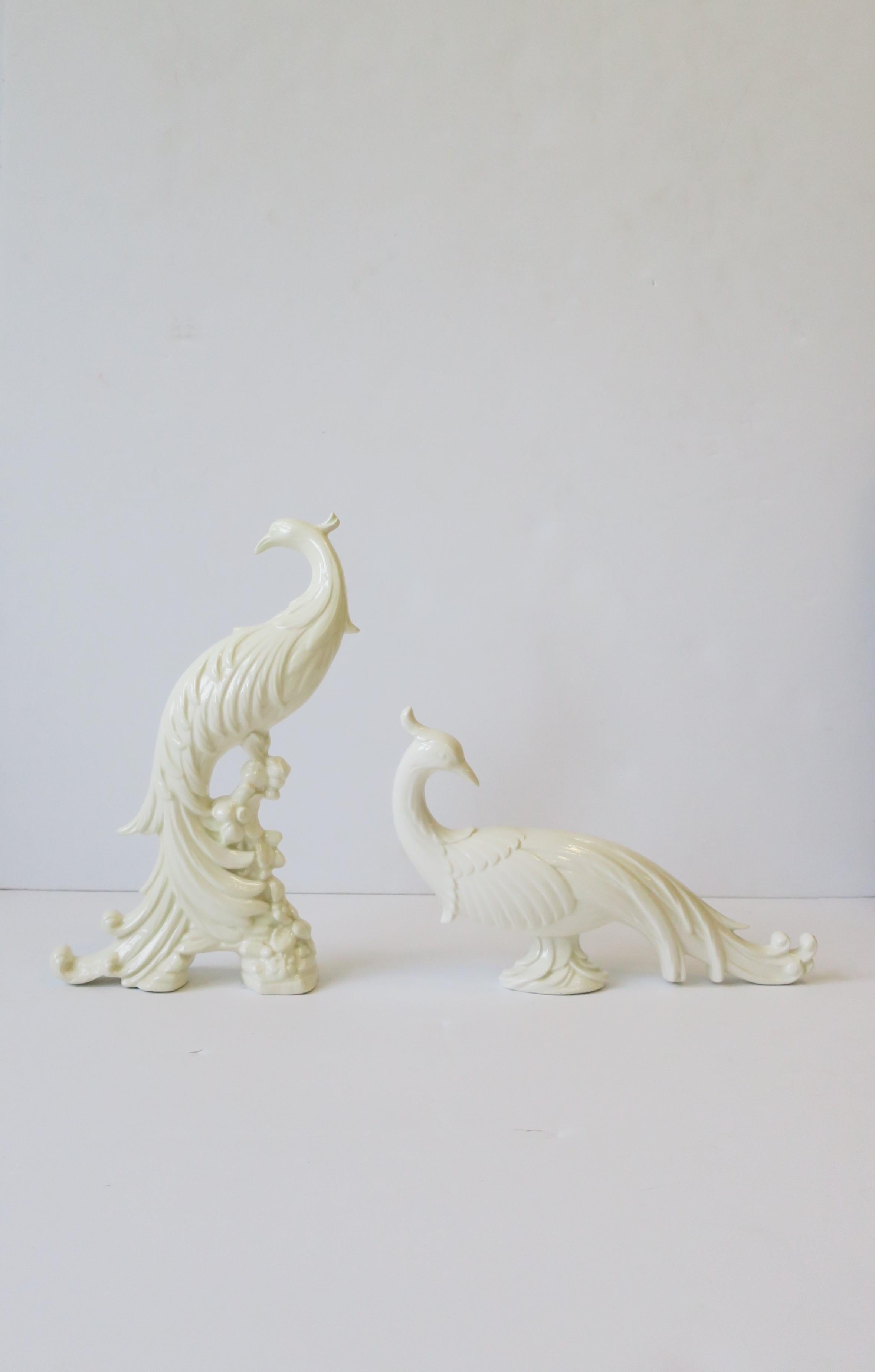 A pair of white ceramic Phoenix or Pheasant birds, circa 1960s. 

Measurements: from L to R
12.75