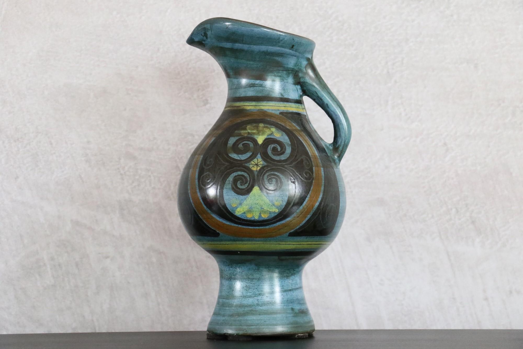 Ceramic Pitcher by Jean de Lespinasse, signed, circa 1960, Volutes Decoration

The dominant colour is blue. It is a very beautiful glaze with a silky appearance and a delicate touch. The colour is enhanced by diffuse black stripes and a greenish
