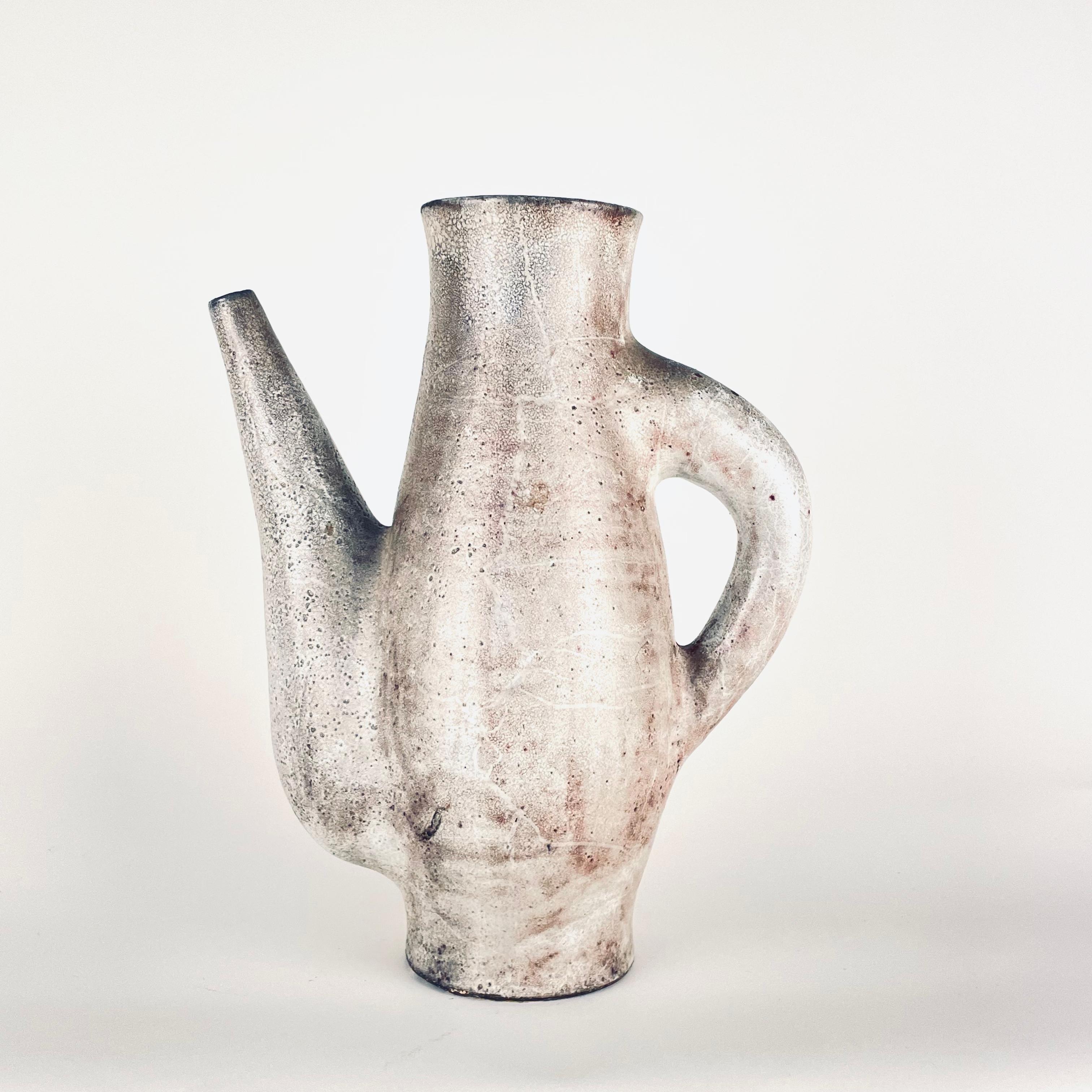 Exceptional and sculptural pitcher (32 cm!) 
White/grey glazed earthenware. Wood cooking. Portal workshop. Vallauris, france. Around 1960. 
Bibliography  Similar model reproduced in the monograph jean derval, ceramist and sculptor, p. Favardin &
