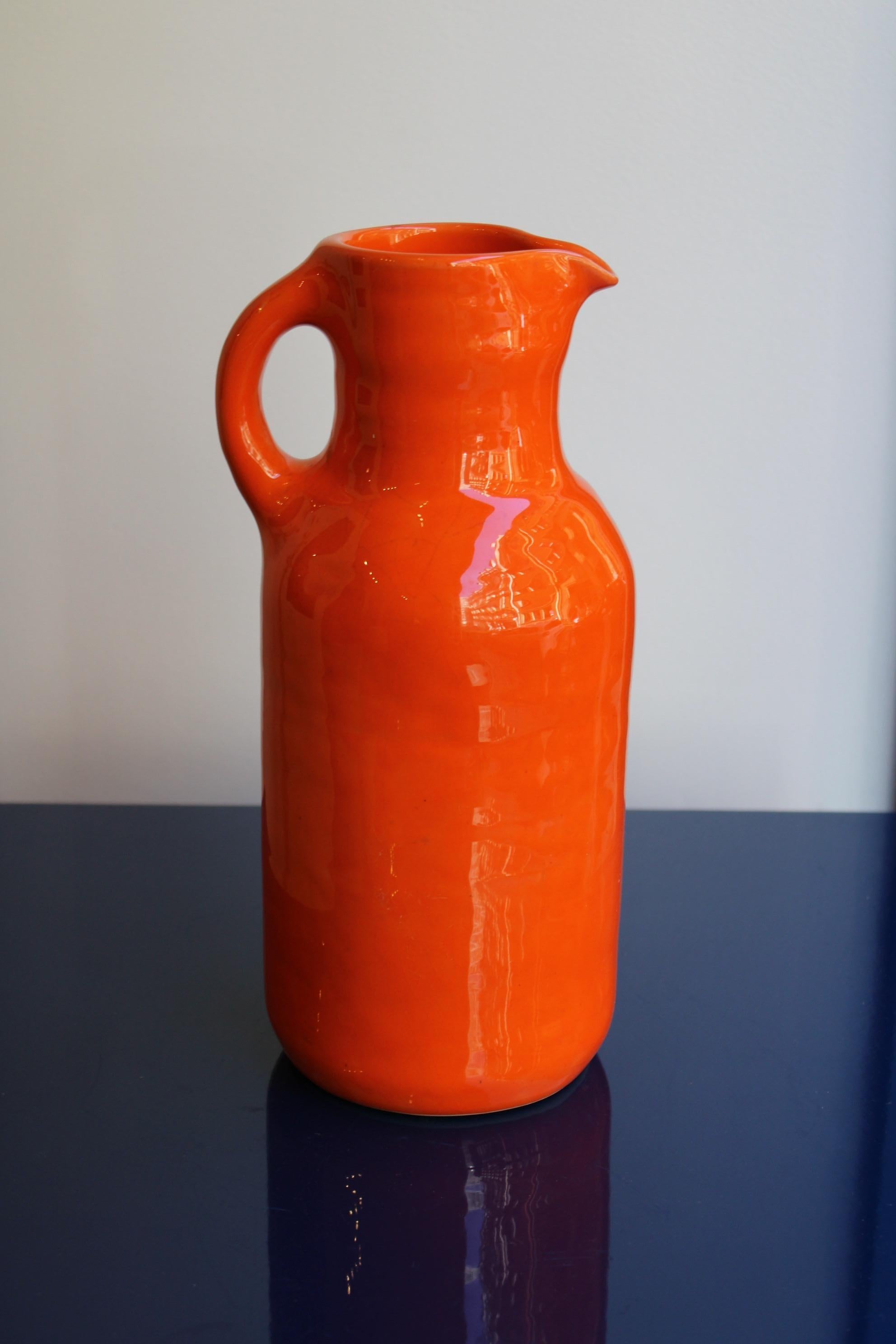 Orange ceramic pitcher by Max Idlas 
France, circa 1960