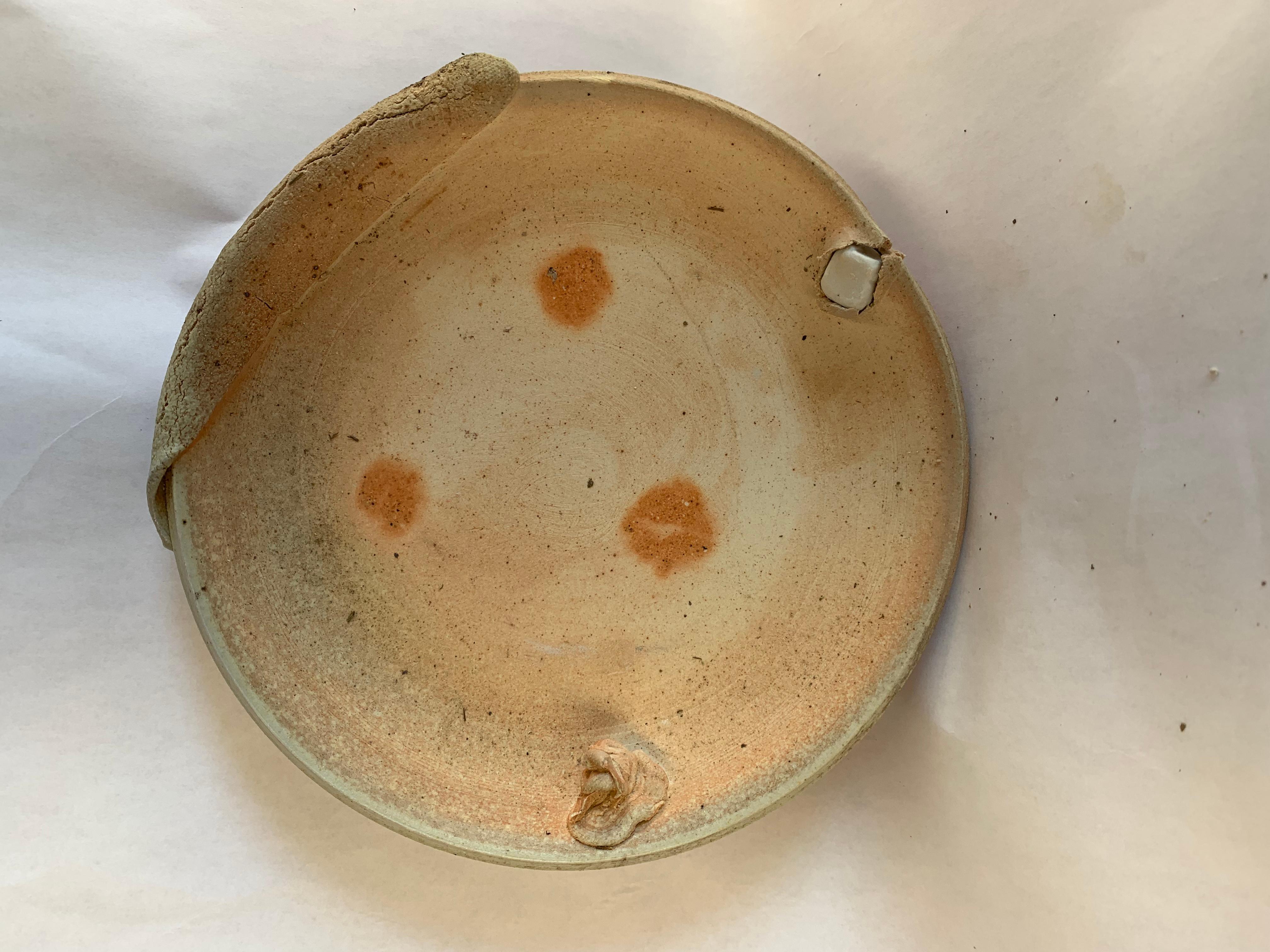 Wood-fired ceramic planter and saucer. These pieces are handmade with a combination of clays, and fired to Cone 10 in a wood-fired kiln. Influenced by Peter Voulkos, these pieces are very individualistic, one-of-a-kind. Functional as a flowerpot, or