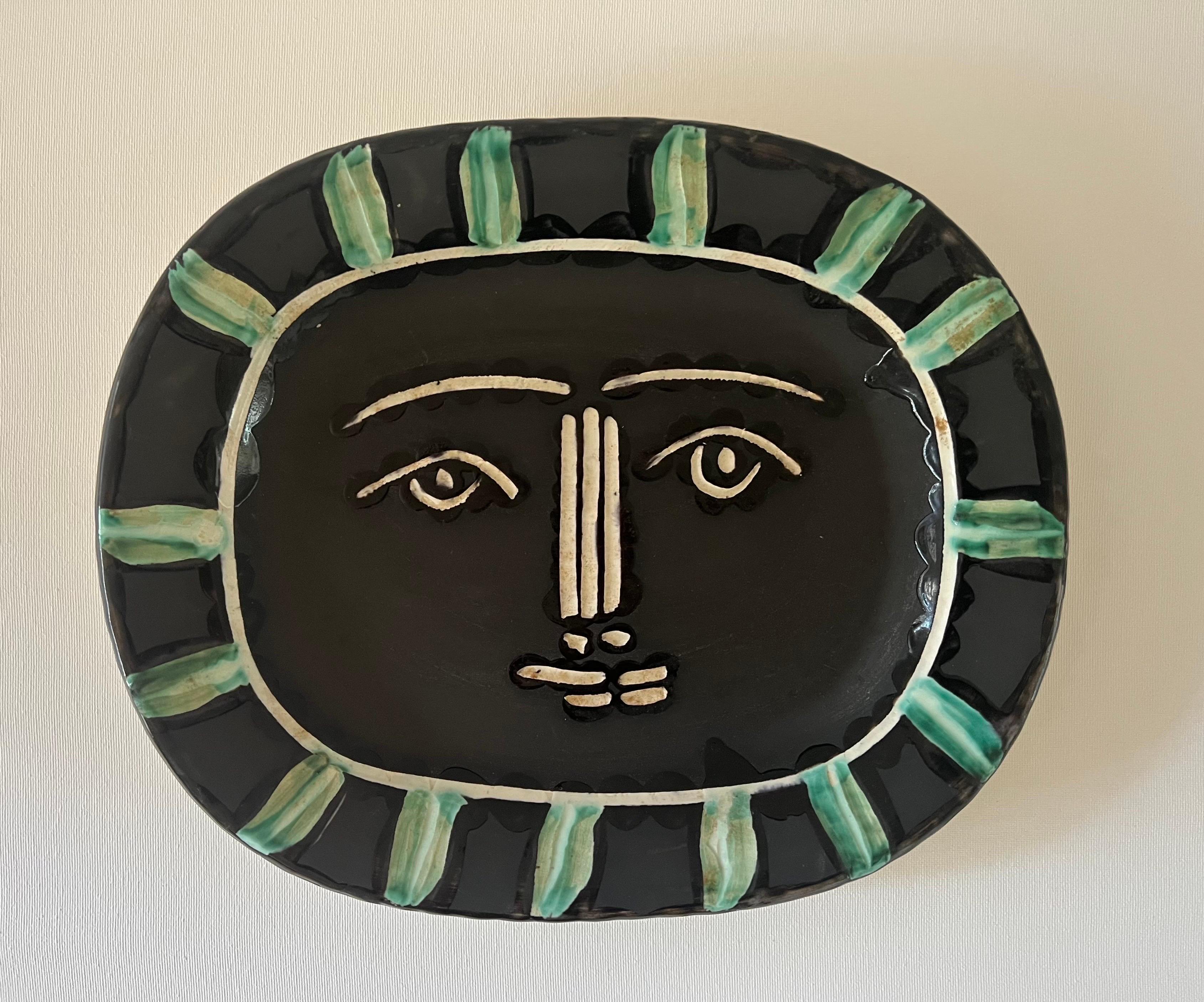 The engraved and brush painted ceramic plate, Visage Gris (Grey Face) is one the most iconic pieces created by Pablo Picasso (1881 - 1973) at the Madoura workshop in Vallauris, France. It is said 
