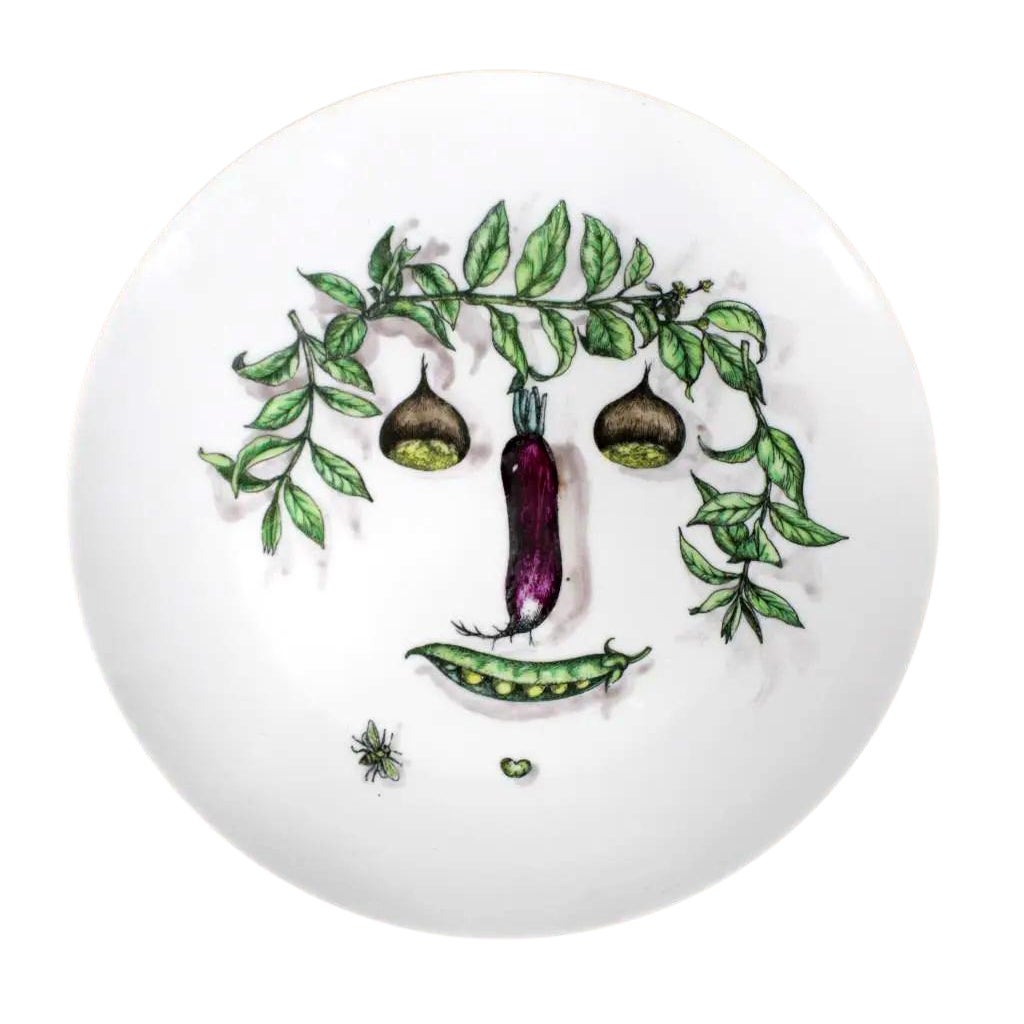 Assiette en céramique avec visage végétal Fornasetti