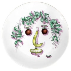 Piatto in ceramica con faccia vegetale Fornasetti