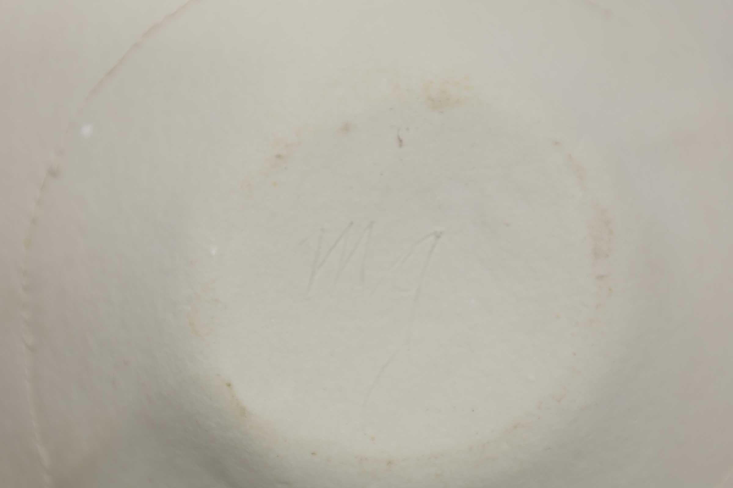 A delicate ceramic bowl with rough edges. No cracks, chips. Signed 