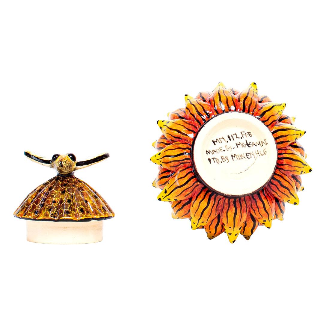 This ceramic protea box is a stunning testament to the artistry of South African craftsmanship. Handmade and painted with meticulous detail, it captures the beauty of the iconic protea flower. The removable lid, adorned with a delicate butterfly in