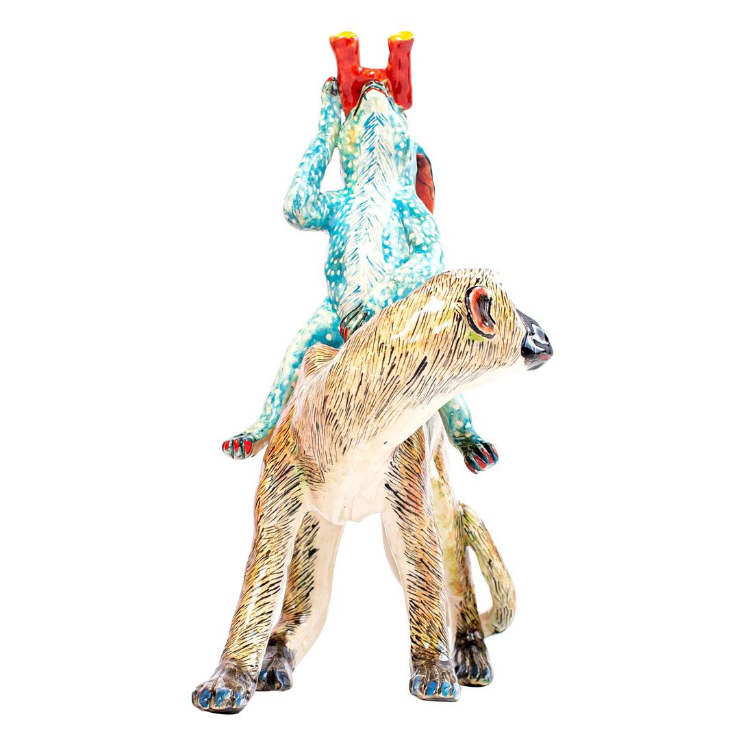The Ceramic Monkey Blue Rabbit Rider from Zimele Ceramics in South Africa is a captivating piece from the African Circus collection. Hand-sculpted by Sneh and hand-painted by Victor, this sculpture measures 10 inches high and 8 inches wide,