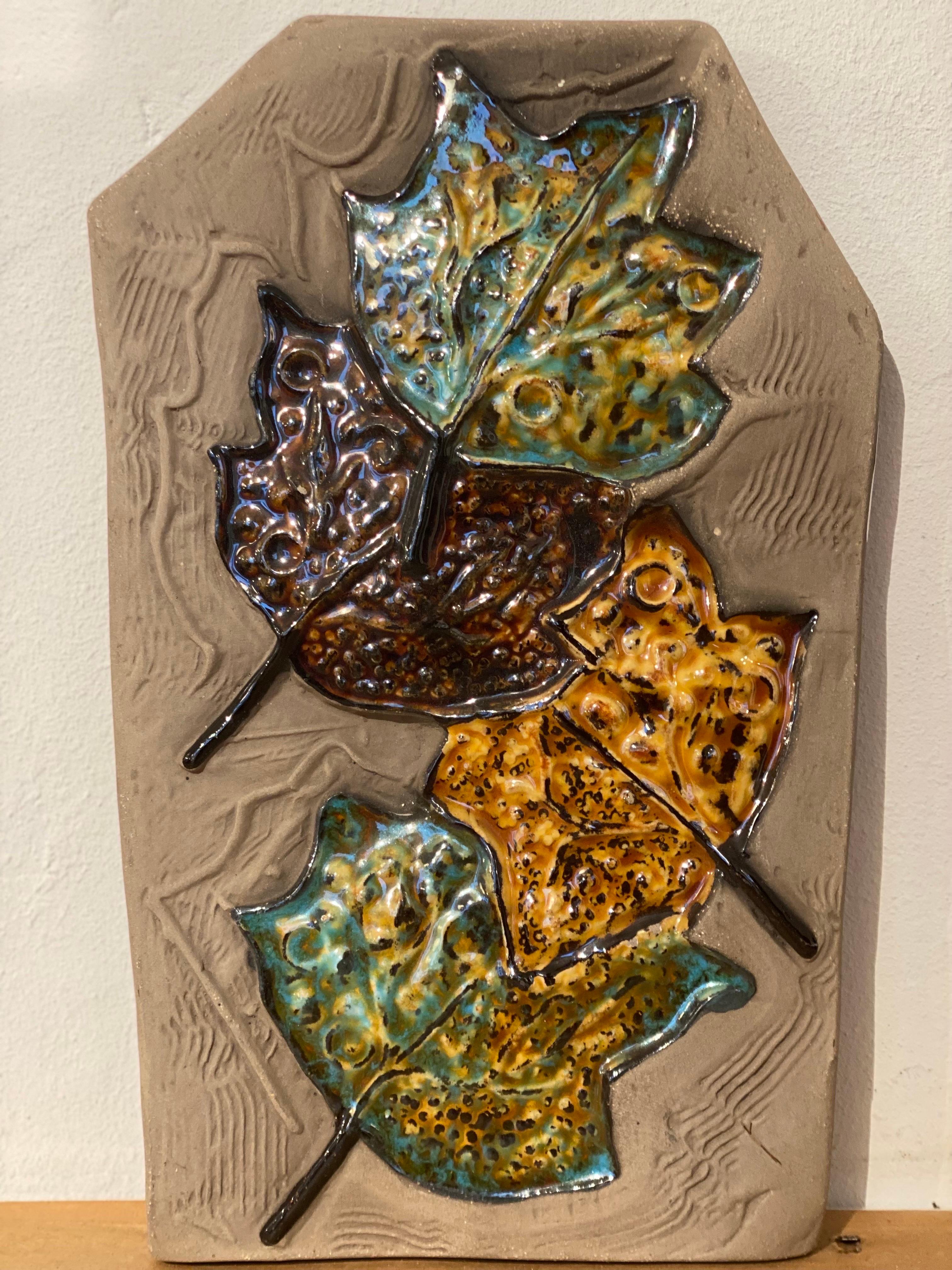 This beautiful wall plaque with autumn leaves is made of molded stoneware and glazed.Designed by Aimo Nietosvuori for JIE Gantofta. Finnish designer who moved to Sweden. In the beginning, he had his own factory, but from 1976, he worked as a