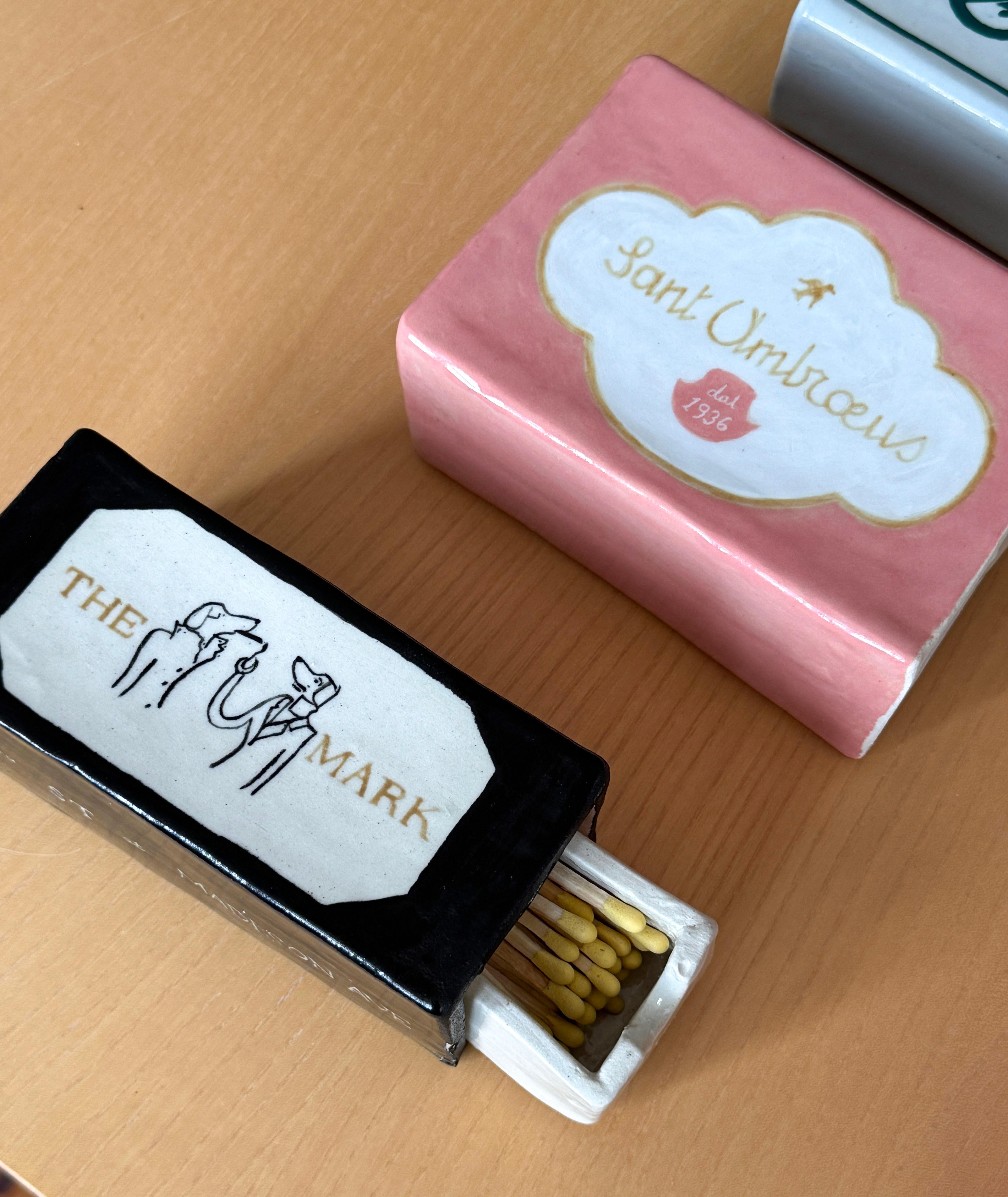 La série Matchbox est composée de boîtes d'environ 4 x 6 pouces qui font directement référence à des institutions emblématiques de New York. Ces boîtes sont munies d'inserts coulissants remplis d'allumettes surdimensionnées, environ 20 à 30 par