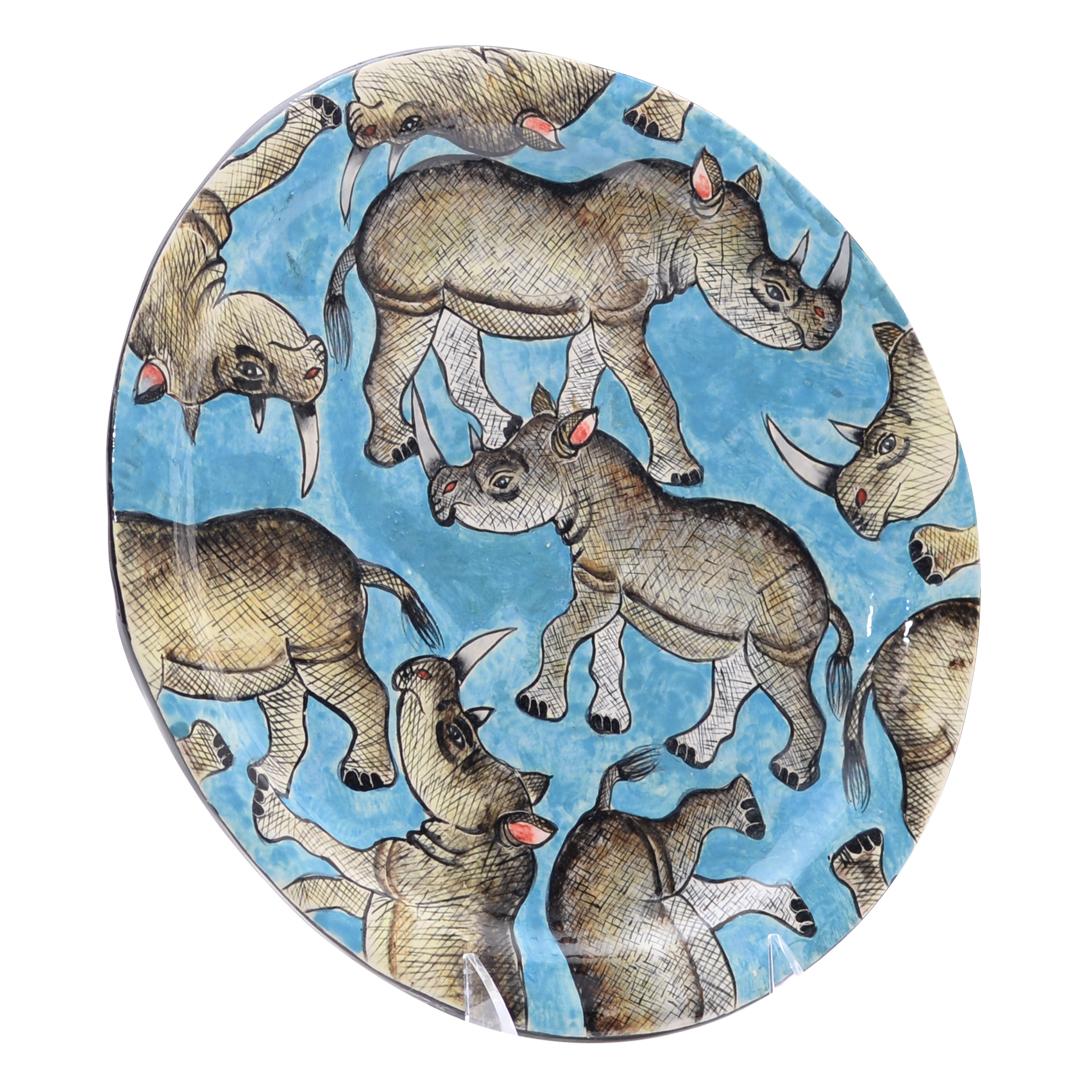 Introducing the Rhino Plate, a remarkable ceramic creation crafted with precision by the talented Nompilo Zaba and hand-sculpted by Victor Shabalala at Zimele Ceramics in South Africa. Measuring 1 inch high, 10 inches in length, and 10 inches in