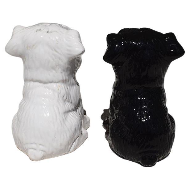 A pair of black and white dog ceramic salt and pepper shakers. 

Dimensions:
3.75