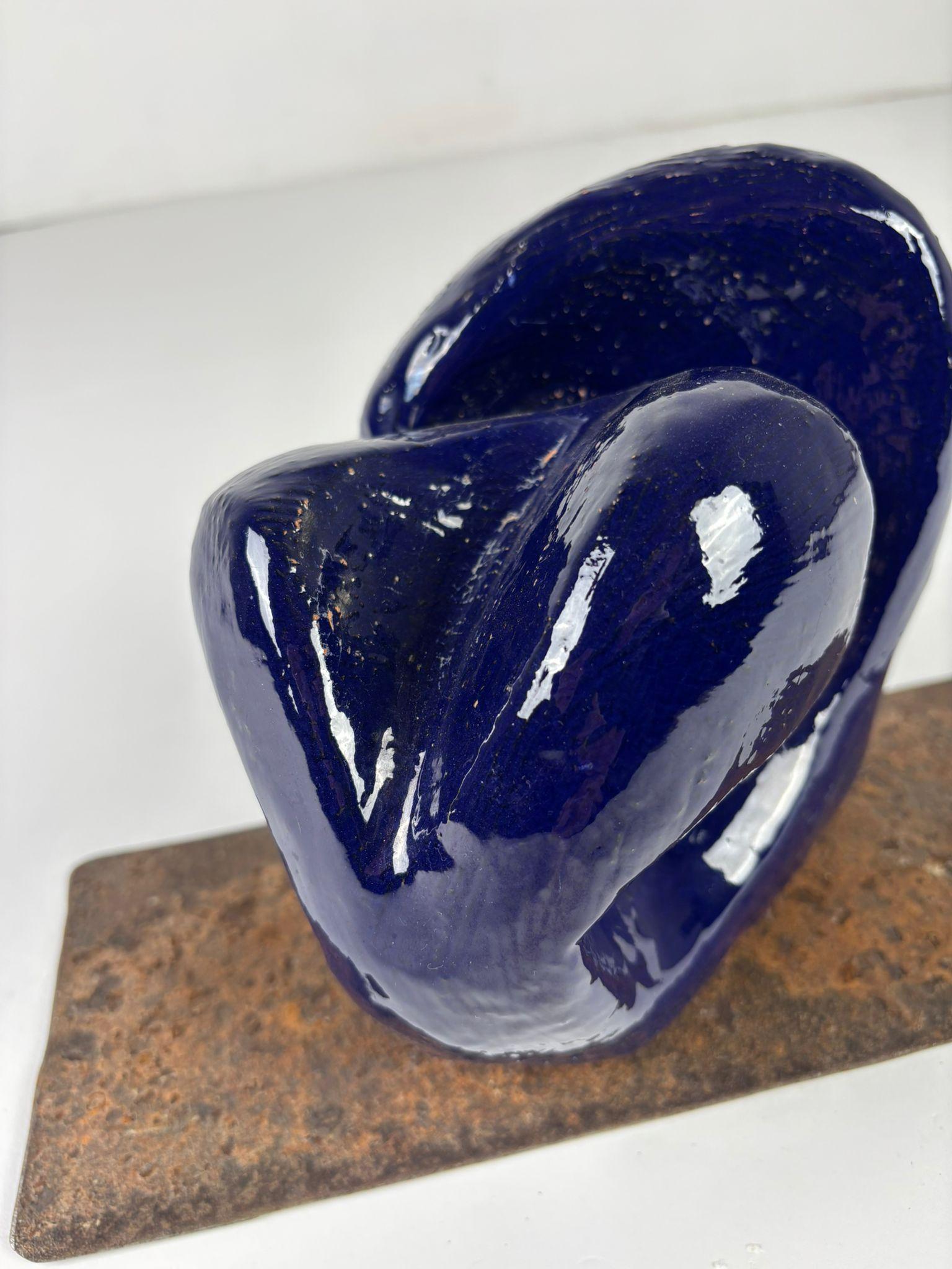 A ceramic sculptural artwork that serves as a unique and refined addition to any sophisticated table within a contemporary interior. Created using the ancient Japanese Raku firing technique from the 16th century, this piece pays homage to tradition