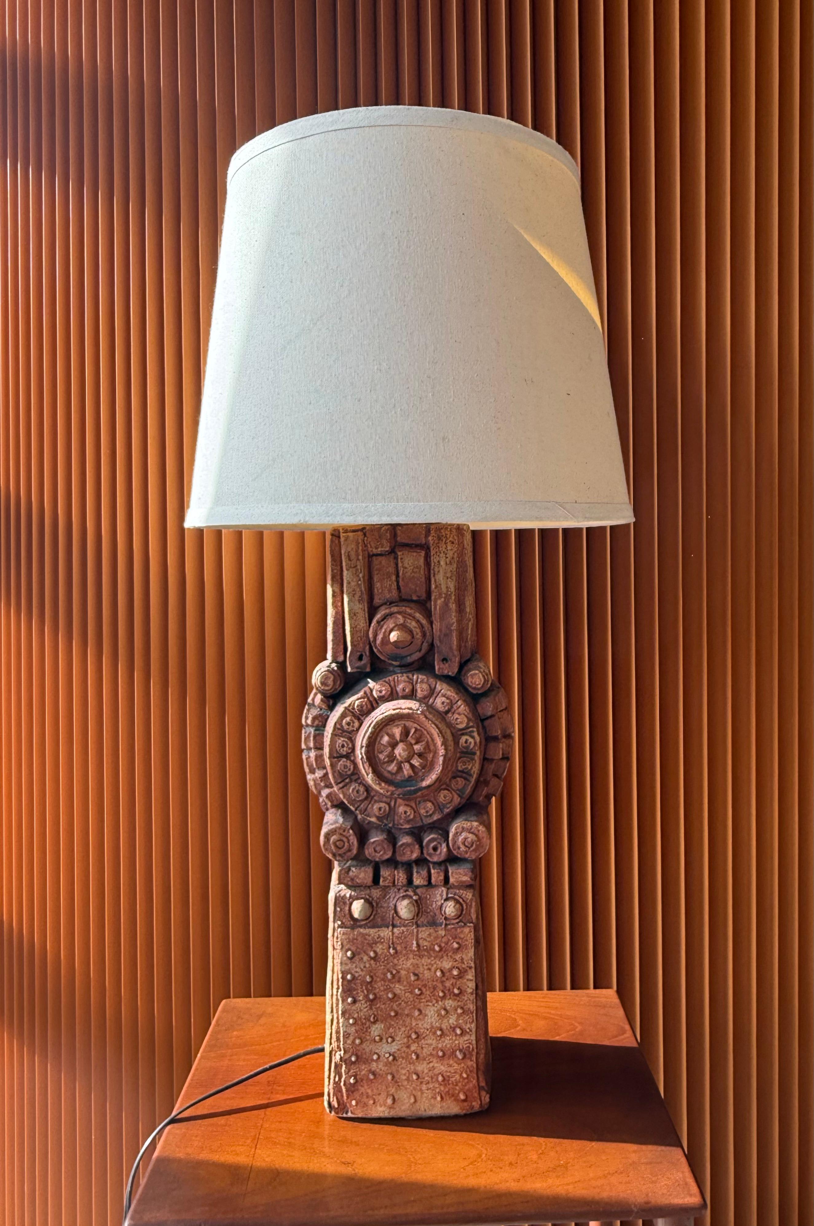 A striking handcrafted ceramic table lamp by Bernard Rooke, an influential British studio potter known for his sculptural, Brutalist-inspired designs. Created in the 1960s, this lamp embodies Rooke’s signature textured surfaces, organic motifs, and