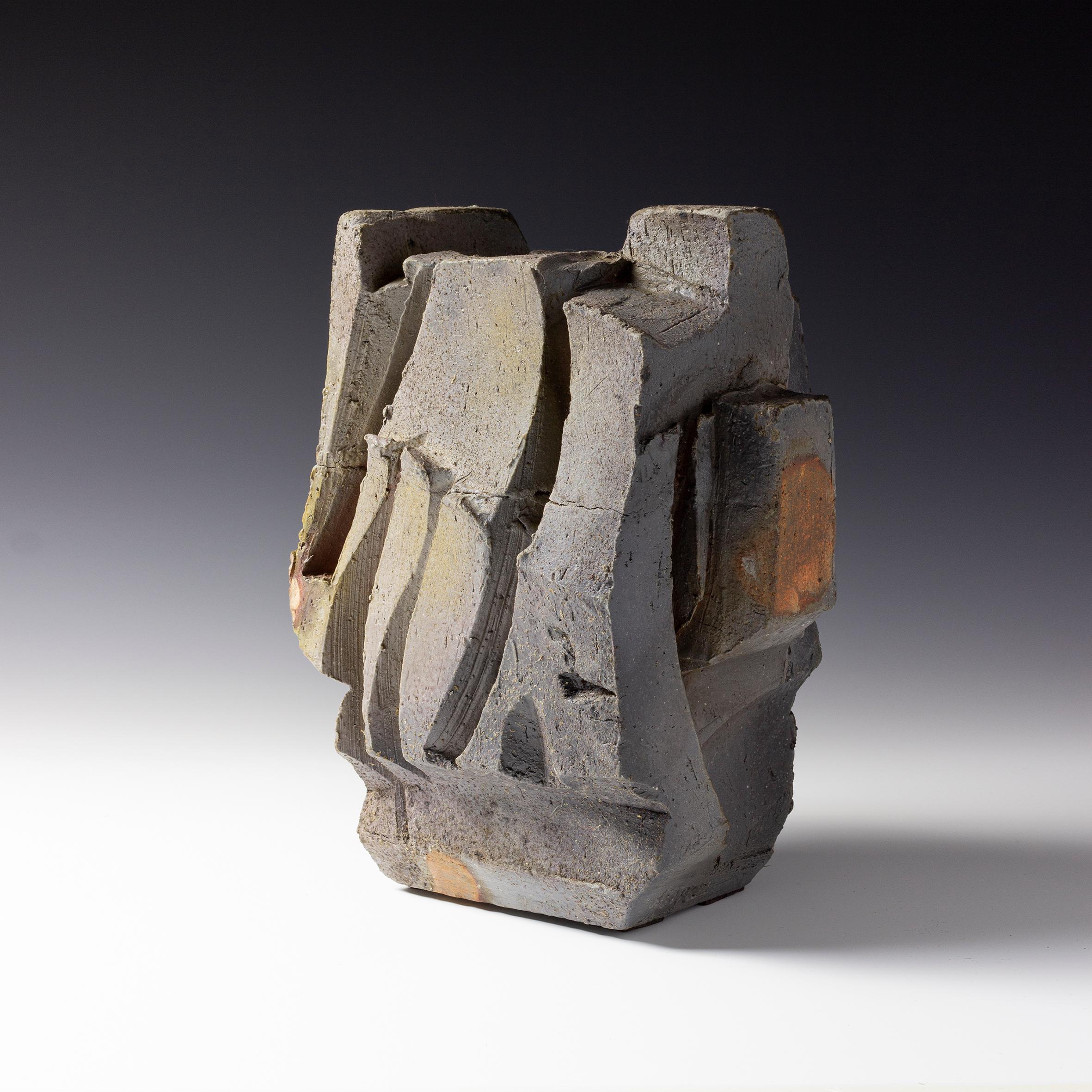 Eric Astoul is a renowned French artist established in La Borne, France. His wood-fired stoneware sculptures are rich in this tension between interior and exterior, an internal surge which seems to be able to shatter the work, its erected walls,