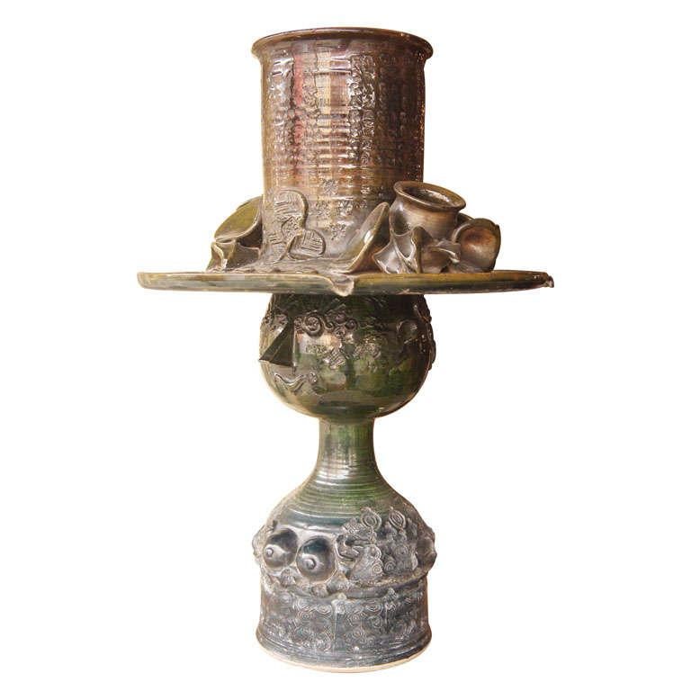 Unusual ceramic piece by Danish artist Bjorn Wiinblad. A fountain, in the form of a bare-breasted woman wearing an extravagant hat. Water trickles off indentations around the hat. Hat lifts off. A pump can be added in the base. In a blue or green