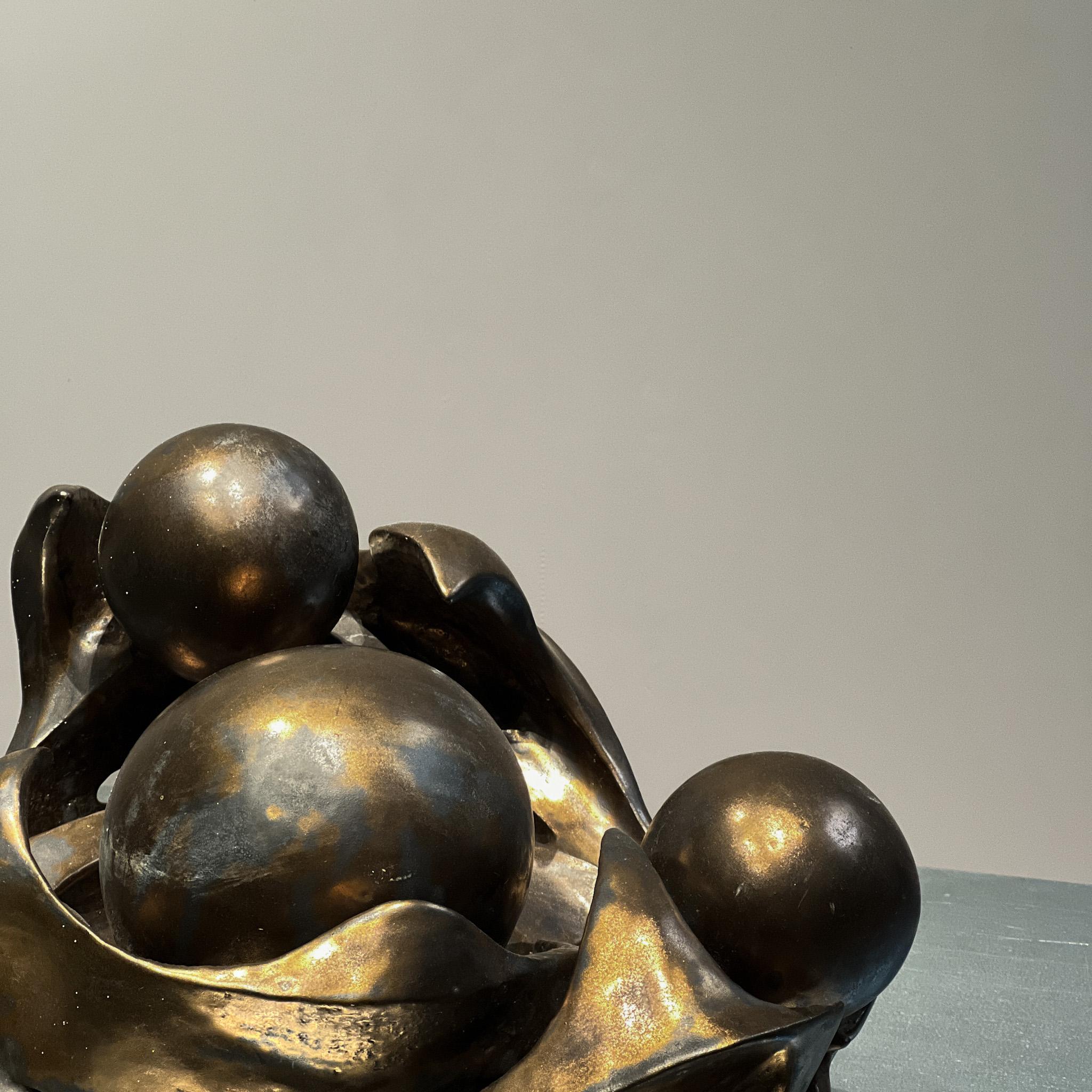 A striking example of 1970s ceramic artistry, this sculptural piece embodies the raw elegance of the Brutalist movement, paired with the sensual, organic lines reminiscent of mid-century biomorphic design. Rendered in richly bronze-glazed ceramic,