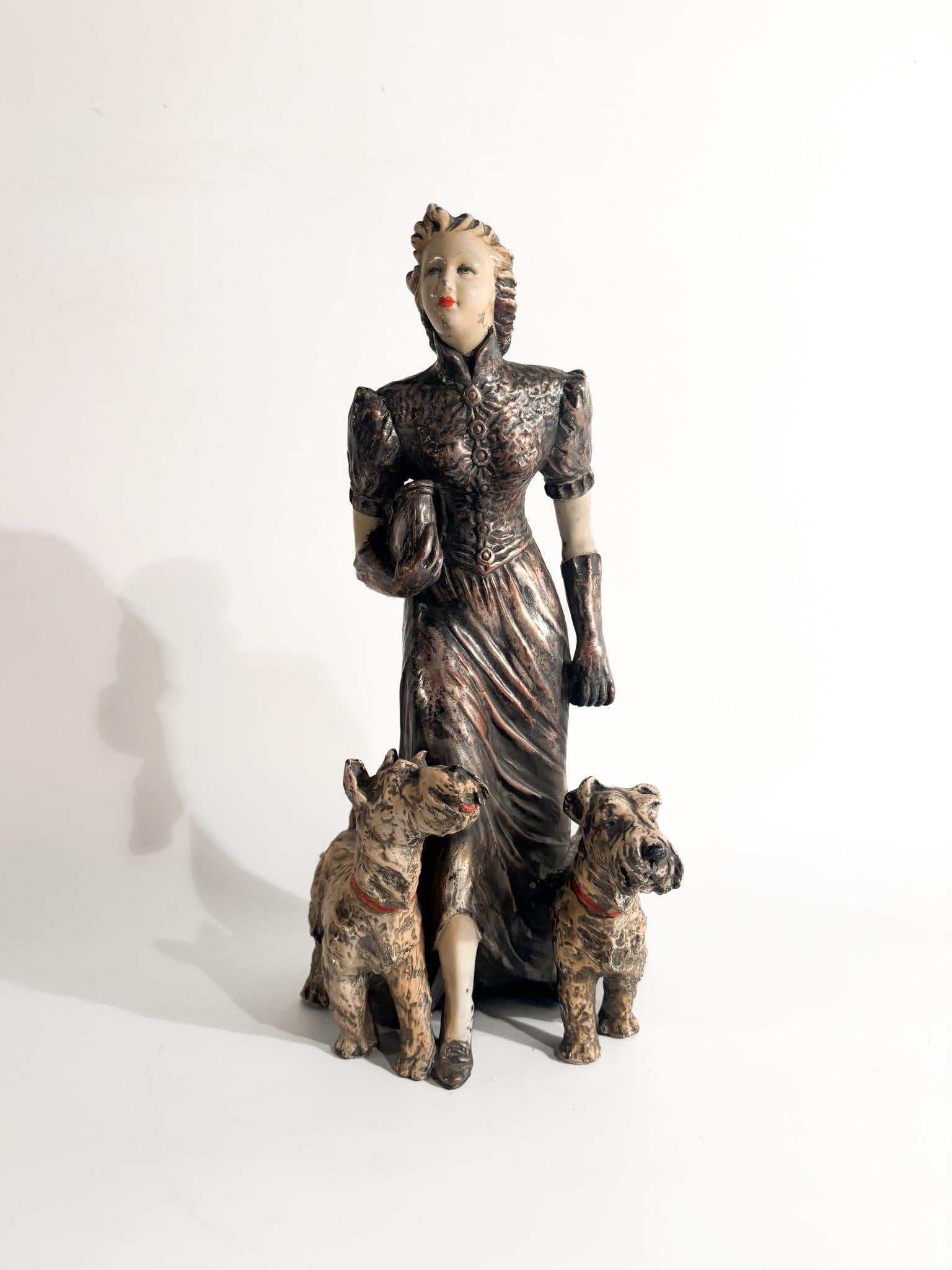 Ceramic figurine by Ceramiche Mollica, depicting a lady with a pair of Fox Terrier dogs, made in the 1940s.

Ø cm 16 Ø cm 15 h cm 30

Ceramiche Mollica represents one of the most important and long-standing manufacturers of Neapolitan ceramics.