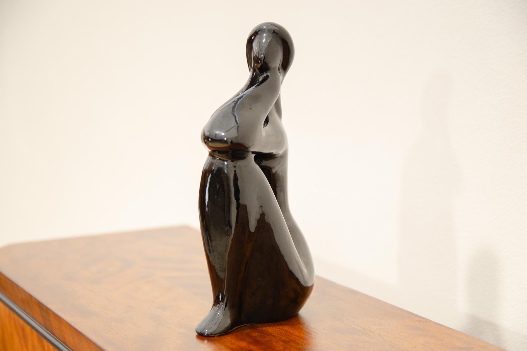 Ceramic sculpture of naked girl designed by Czechoslovak artist Jitka Forejtová. Made in 1960s. The sculpture is made of ceramics with black glaze.
This minimalist design of the statuette fully corresponds to the so-called Brussels period in