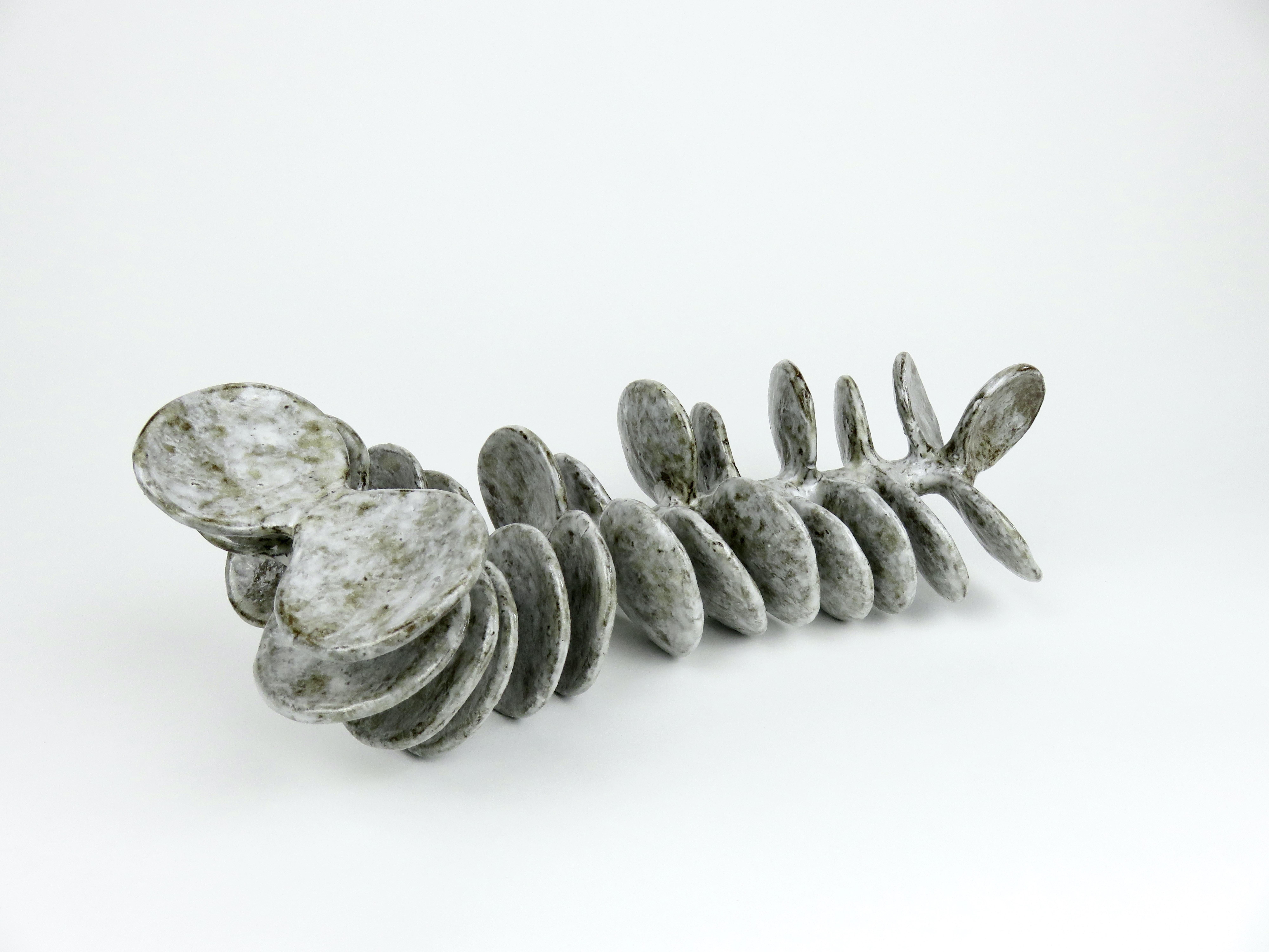 Hand-Crafted Ceramic Sculpture, Reclining Skeletal Spine in Mottled White and Brown For Sale