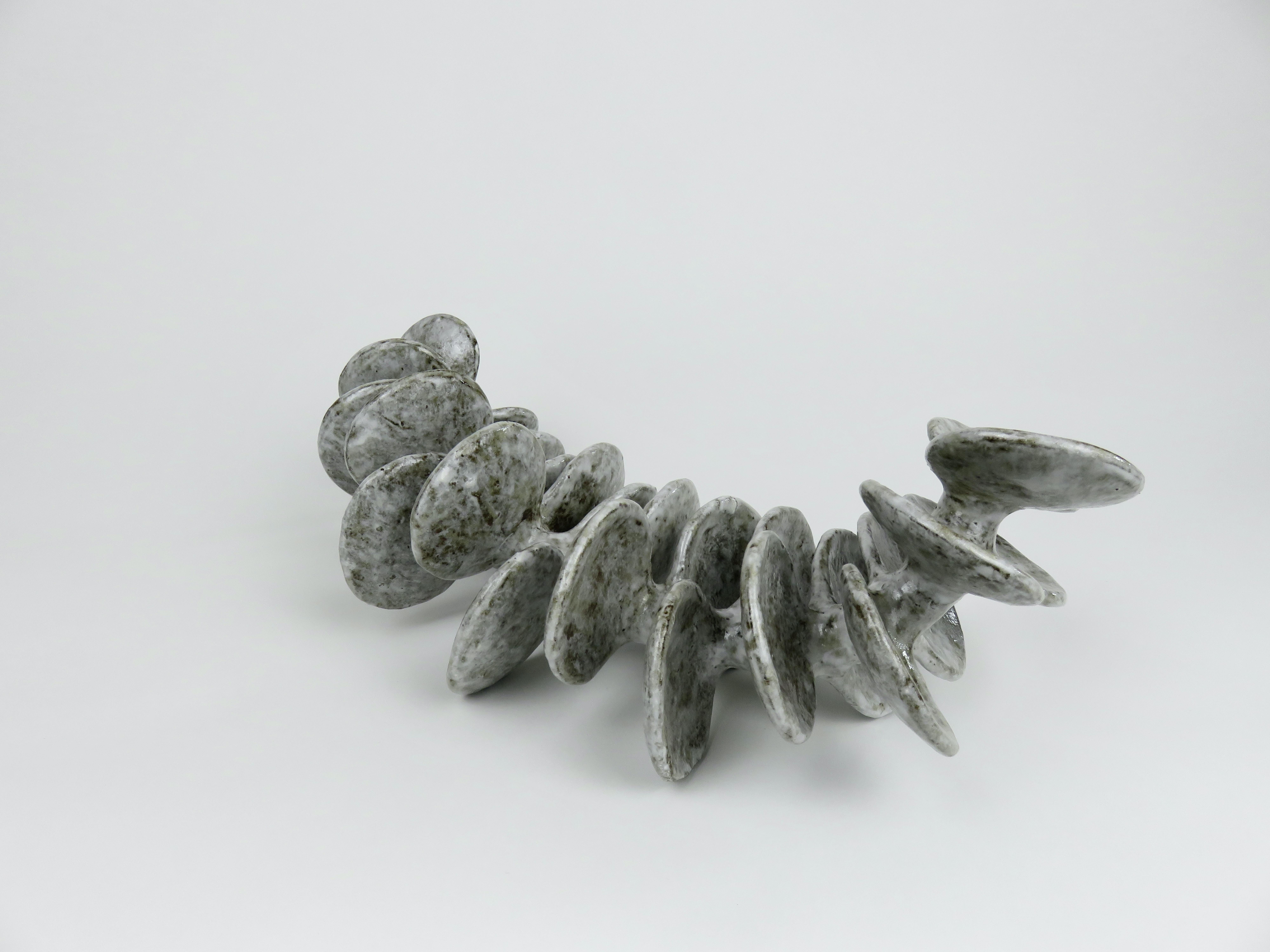 Ceramic Sculpture, Reclining Skeletal Spine in Mottled White and Brown In New Condition For Sale In New York, NY