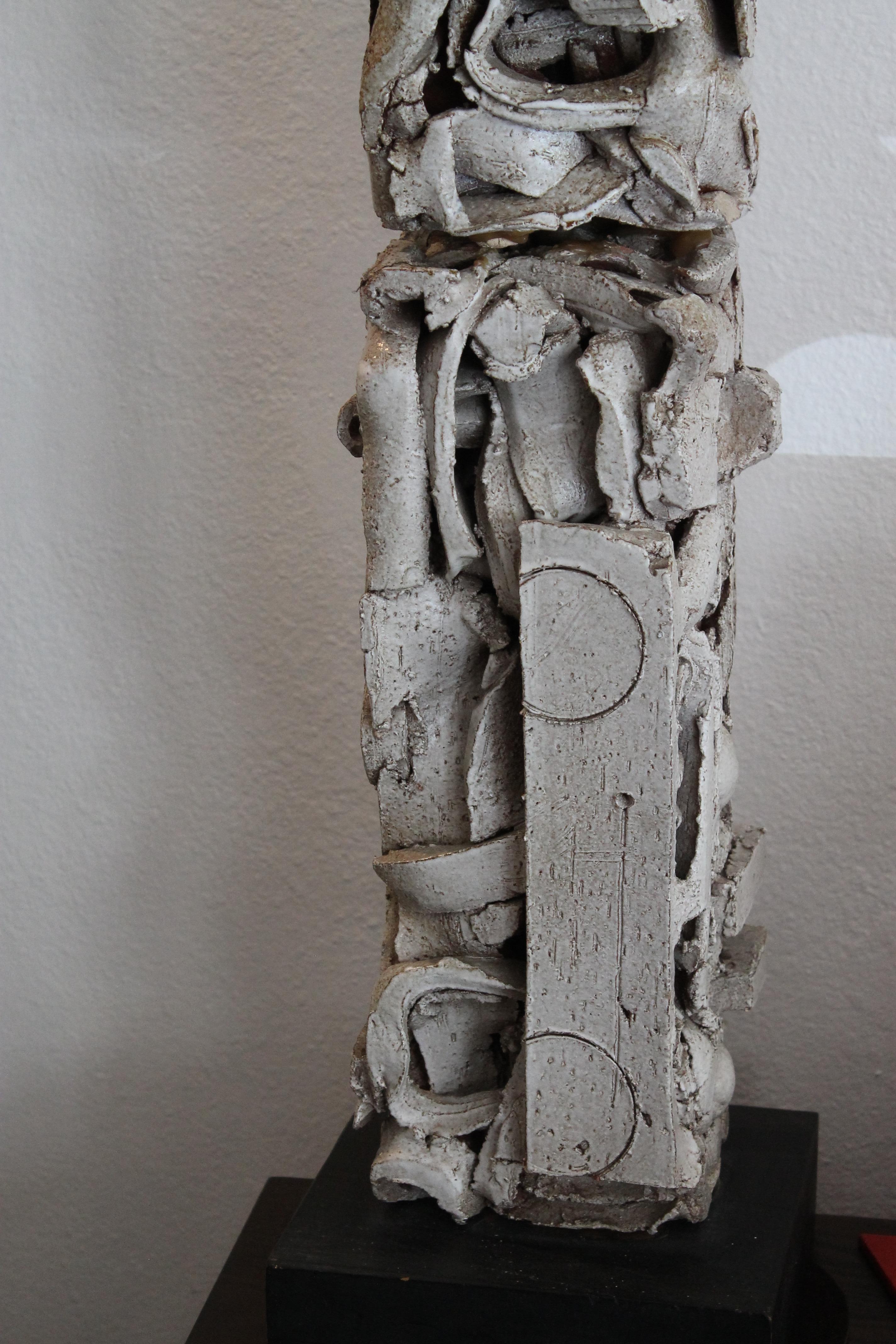 Totem two-piece ceramic sculpture signed and dated 1970 on stand. Ceramic portion consists of 2 pieces. Both in place measure 6.5