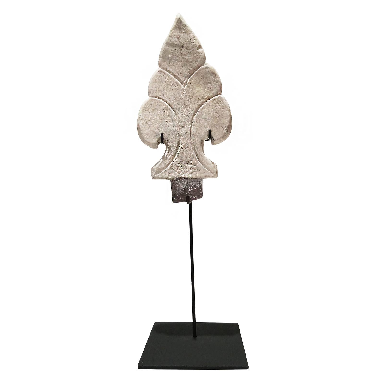 A shield-shaped antefix ornament from Thailand, late 19th century. 

Reclaimed from old constructions and preserved in time, these architectural details were and still are a decorative staple in many traditional Thai buildings, particularly temples,