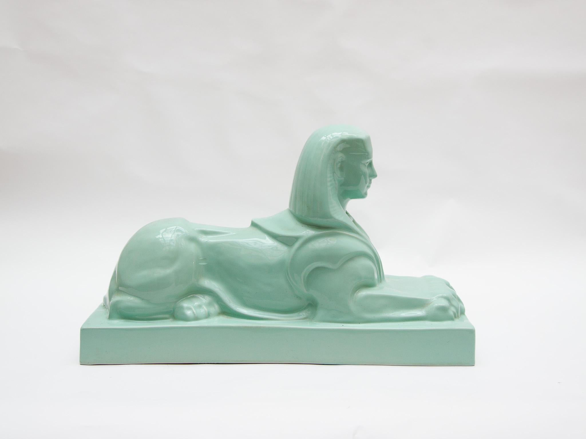 A particularly beautiful glazed earthenware Sphinx statue made by De Sphinx N.V. in Maastricht (Petrus Regout) and designed by the famous sculptor Charles Vos (1888-1954) Maastricht.
Depicted is a beautiful sphinx, standing guard, lying on a dais.