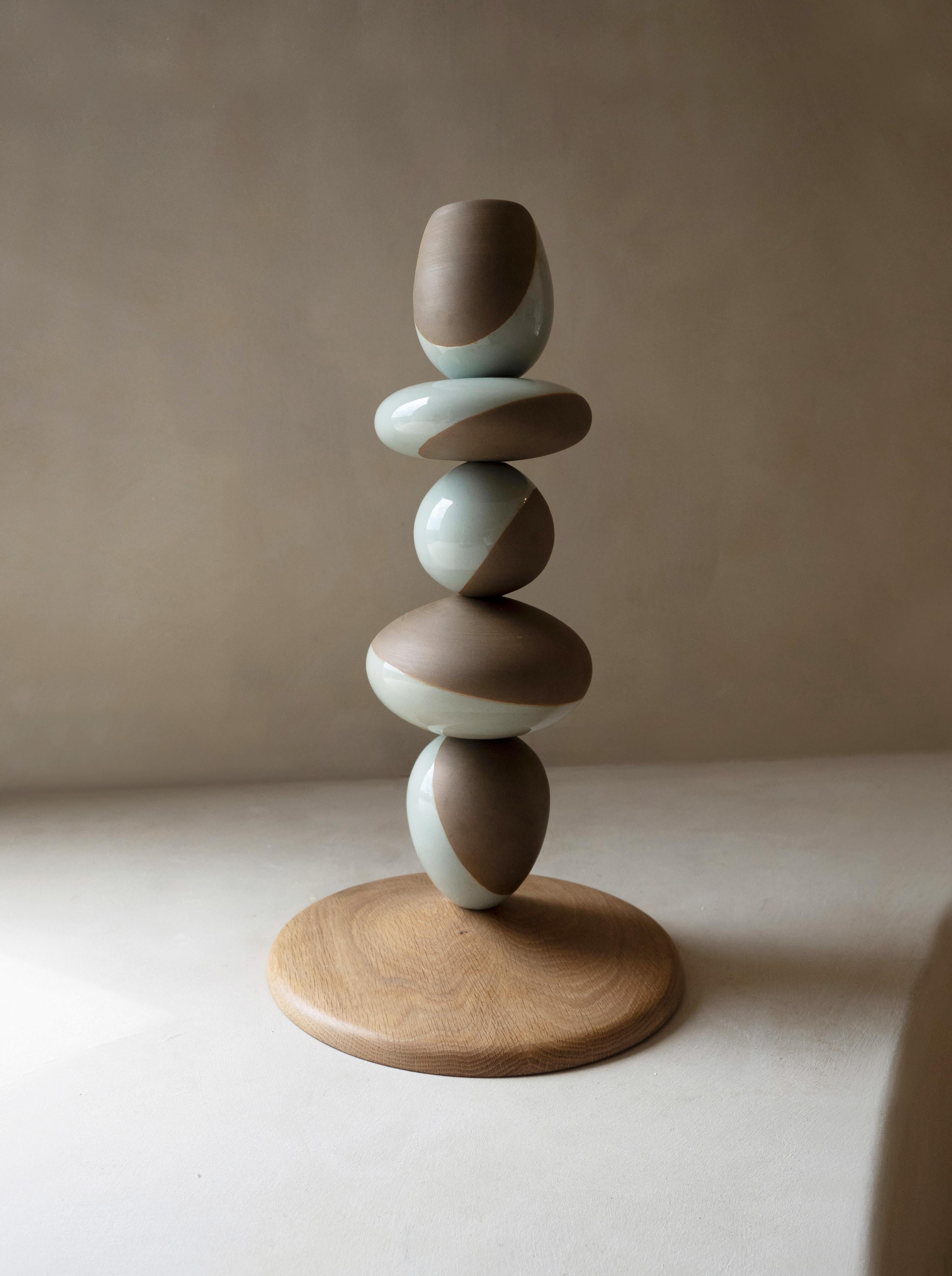 Stack Vessel II by Soo Joo is a stack sculpture made in Korean Ceramic. It is a timeless form, reminiscent of a stack of perfectly balanced river stones. This is the shorter of the two Stack Vessel pairs. The Stack Vessel series is created with