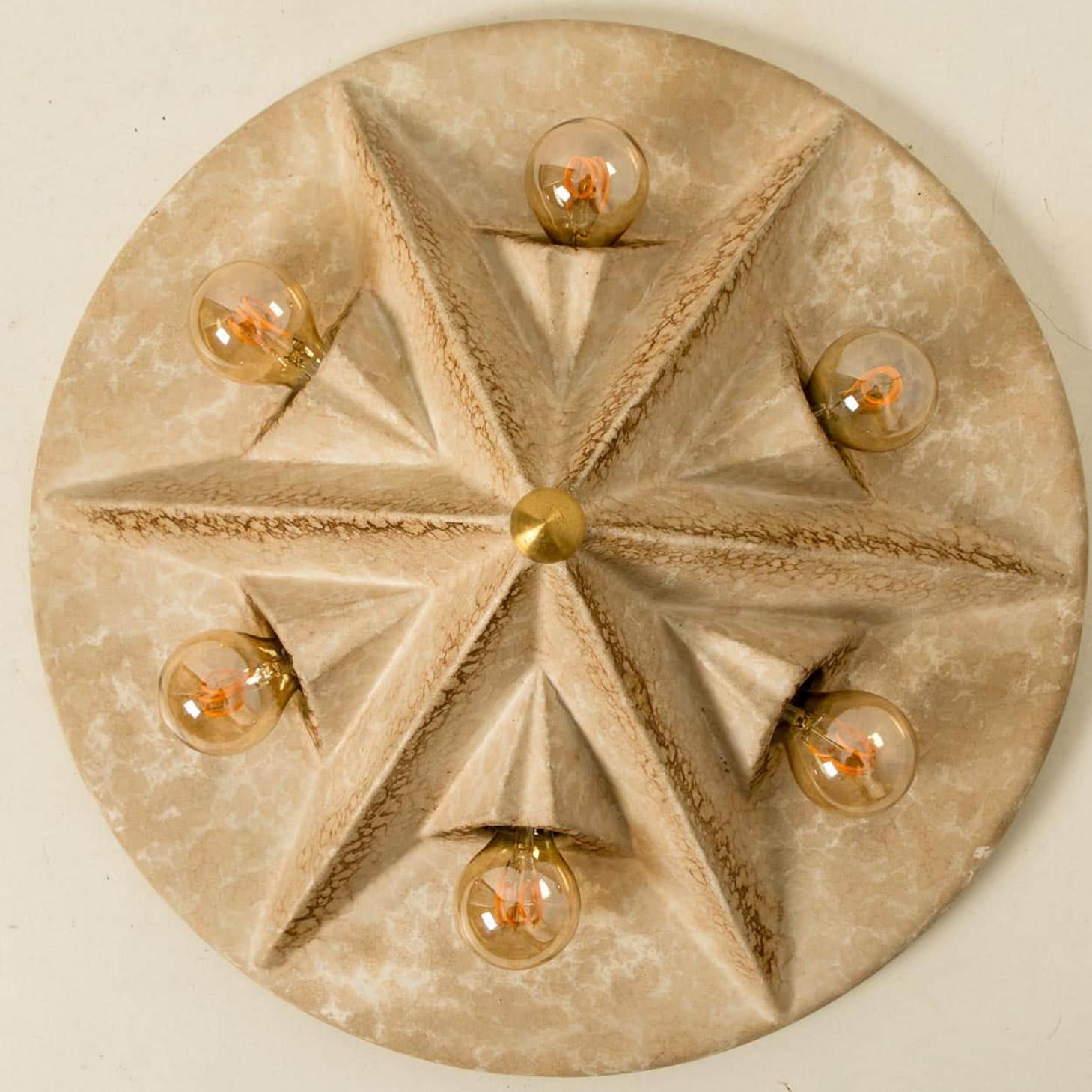 Belle et graphique lampe murale ou de plafond en forme d'étoile, en céramique de couleur beige, fabriquée dans les années 1970 en Allemagne.

Nous avons utilisé des ampoules dorées douces (voir images), mais les ampoules miroir argentées, fumées ou