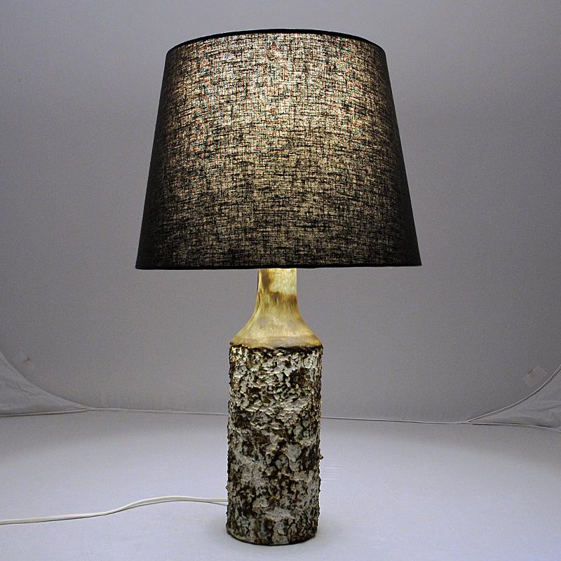 A special table lamp designed as a round birch tunk by Bruno Karlsson for Ego Stengods Atelje, Sweden 1970s. With speckled grey, brown and and white mix of colors as in the birch tree and with a rough and knotted forest texture. Perfect in every