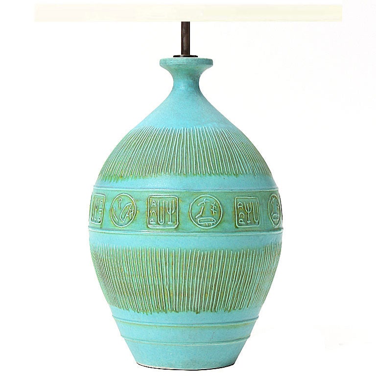 A ceramic table lamp with turquoise and green glaze with relief detail. Designed by Bitossi, produced in Italy by Raymor, circa 1960s.