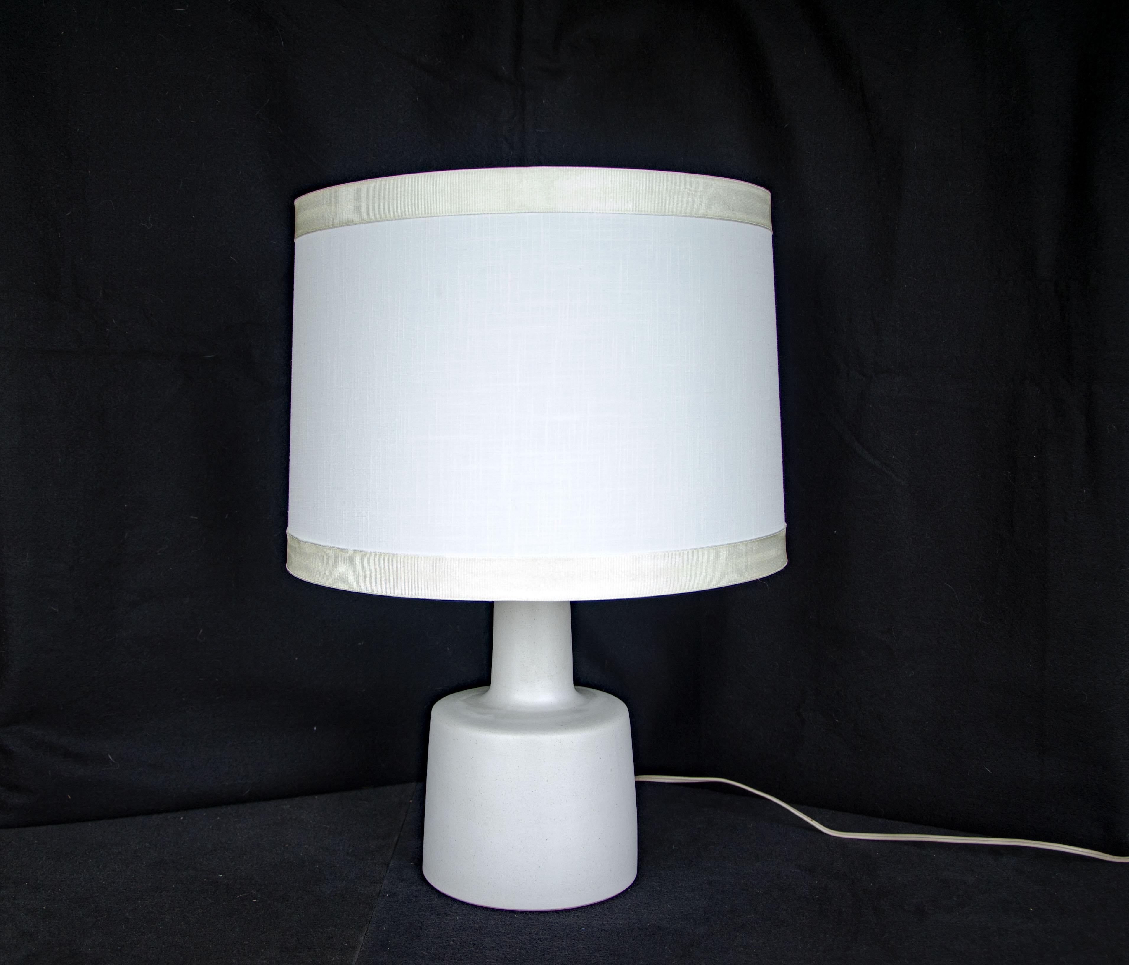 Very nice smaller size table lamp with an antique white ceramic base and signature walnut finial. The Martz signature is on the back of the ceramic base near the cord. A perfect lamp for a desk, dresser, or bedside table. The white base has a matte