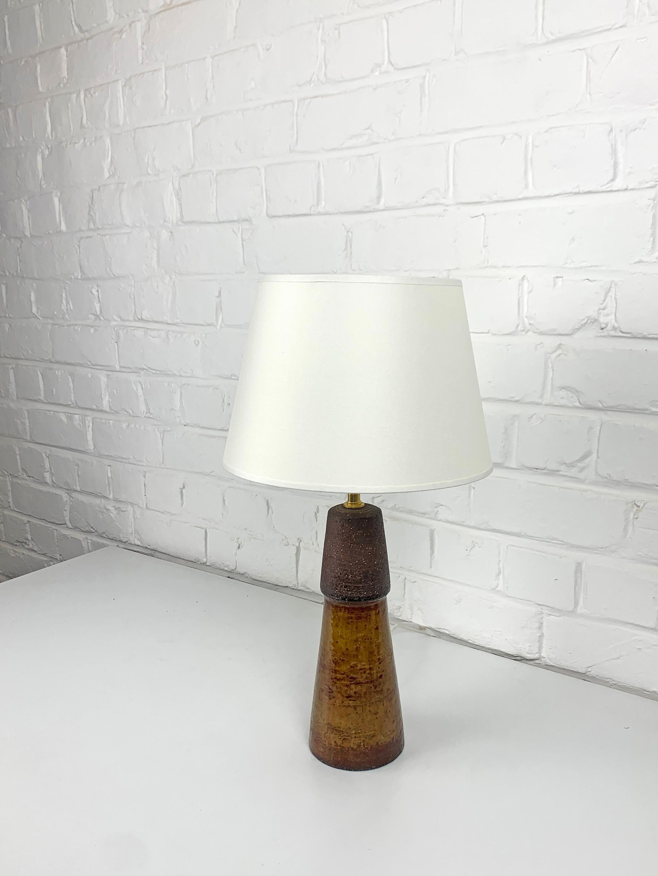 Table Lamp produced in the 1960s by Michael Andersen & Sons in Bornholm, Denmark. 

The lower part of the lamp has a deep ocre glaze, the upper part comes in a rough natural clay finish in dark brown. 

It is signed under the base M.A&S. (for